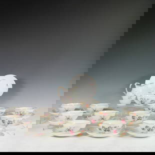 25pc Royal Copenhagen Frijsenborg Porcelain Cup and Saucer Set with Creamer: A 25-piece porcelain tea service by Royal Copenhagen in the Frijsenborg pattern, including 12 teacups, 12 matching saucers, and one creamer. This elegant design features hand-painted floral bouquets i