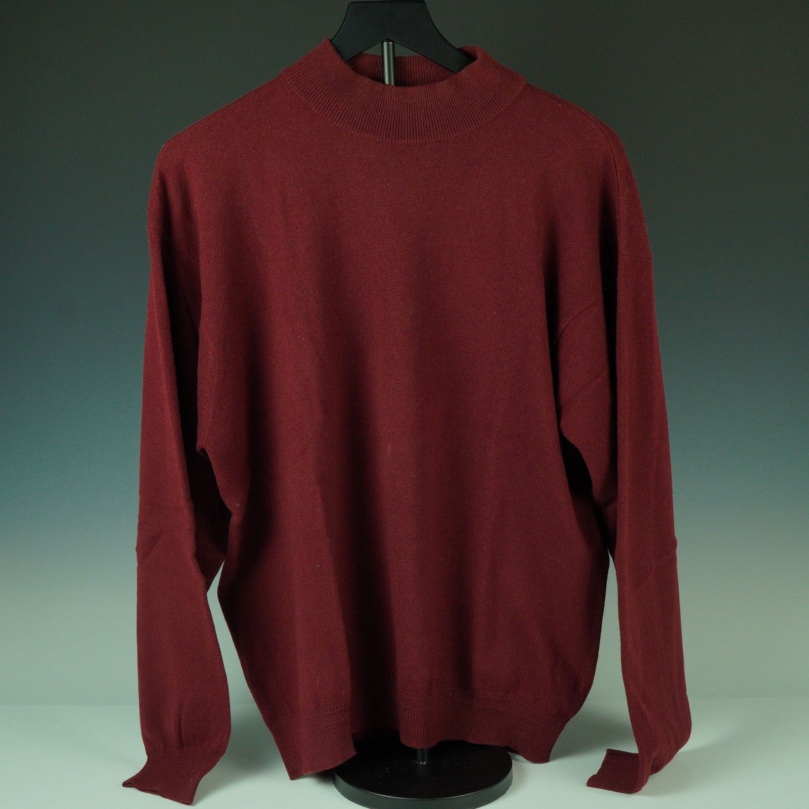 Gianni Versace Burgundy Cashmere Turtleneck Sweater: A refined and timeless piece from Gianni Versace, this burgundy turtleneck sweater is crafted in luxuriously soft 100% cashmere. The garment features a minimalist silhouette with a ribbed high necklin