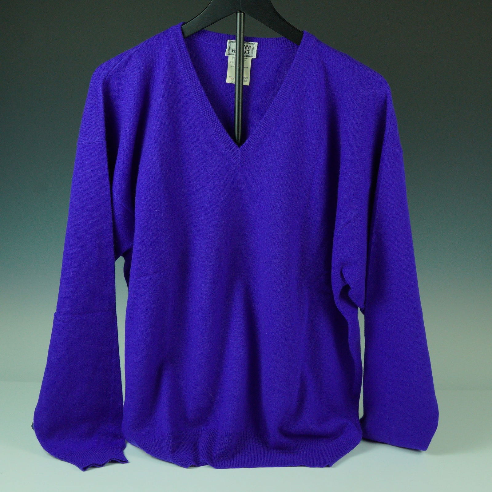 Gianni Versace Purple Cashmere Turtleneck Sweater: Striking in color and refined in construction, this vintage Gianni Versace turtleneck sweater is crafted entirely from luxurious 100% cashmere in a rich royal purple hue. Featuring a ribbed high neckl