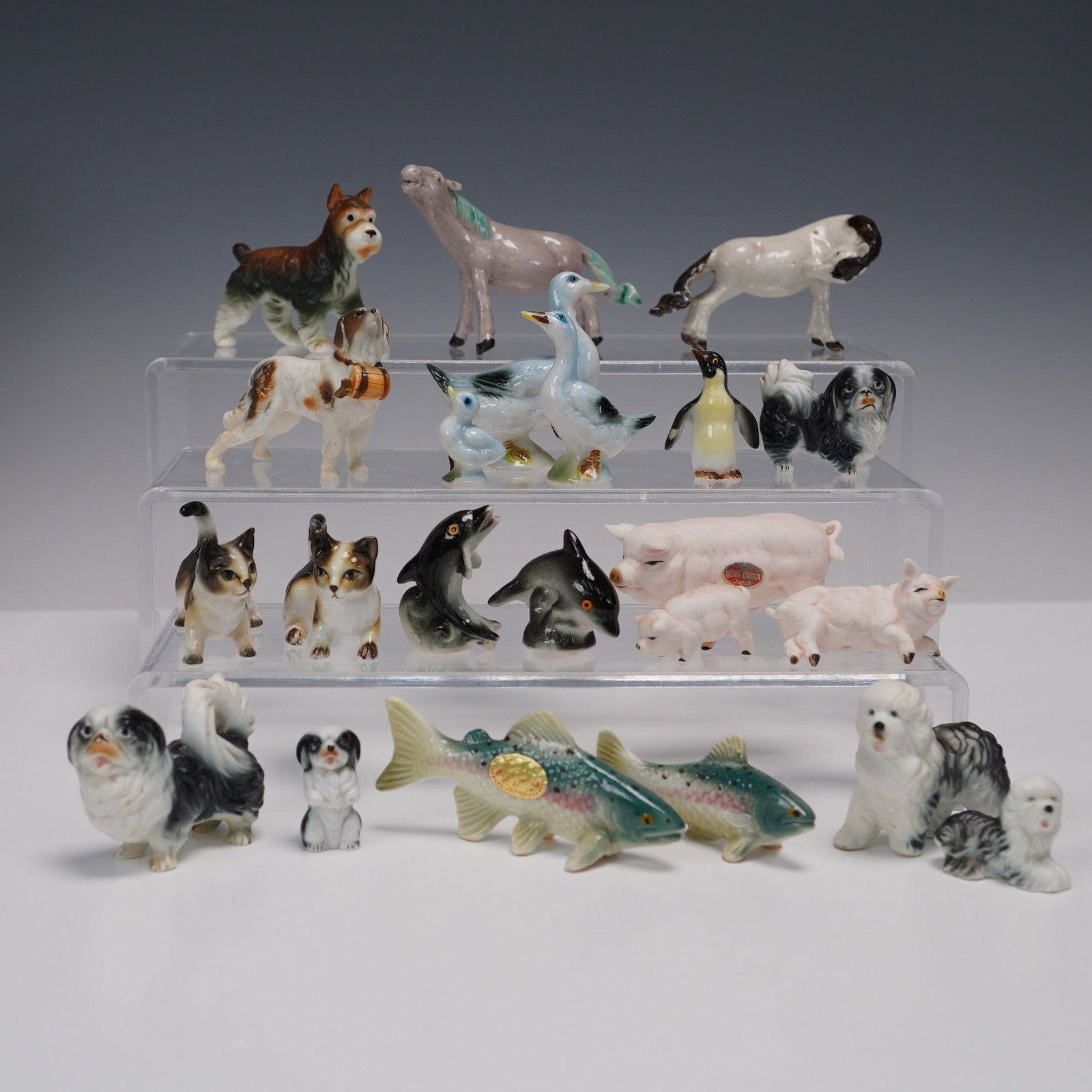 22pc Miniature Porcelain and Bone China Animal Figurines: A varied collection of twenty-two miniature animal figurines, including examples marked "Genuine Bone China - Taiwan" alongside unmarked companions. The grouping features a delightful mix of animals s