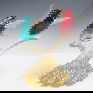 Murano-Style Art Glass Sculpture of Birds on Branch: A colorful Murano-style blown glass sculpture featuring two perched birds, one in deep ruby red and the other in vibrant teal, with delicately formed wings rendered in clear glass flecked with gold. T