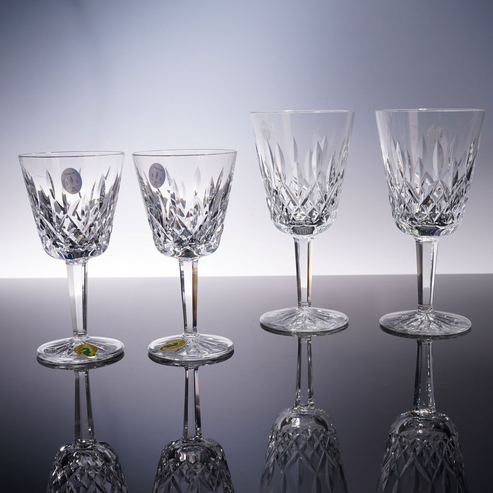 4pc Waterford Crystal Claret Wine and Water Goblets, Lismore: A coordinated set of four glasses, comprising of two Claret Wine glasses and two Water goblets, meticulously designed in the Lismore pattern. The bowls are adorned with crosshatched diamond cuts and u