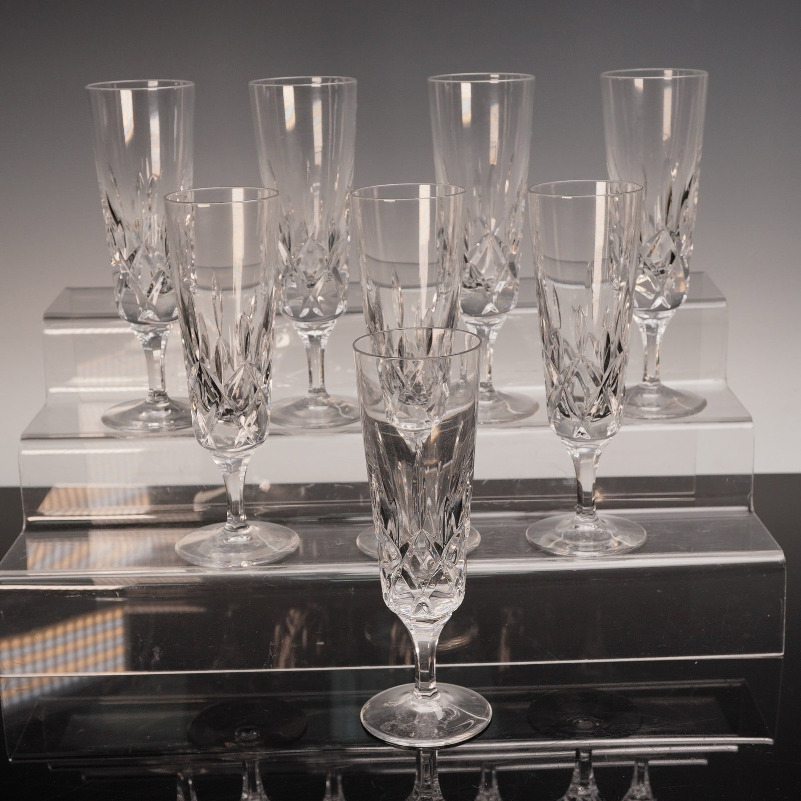 8pc Gorham King Edward Crystal Champagne Flutes: Set of eight cut crystal champagne flutes in the King Edward pattern by Gorham. Each flute features a faceted bowl with a crisscross motif of elongated diamonds, creating striking visual depth and bri