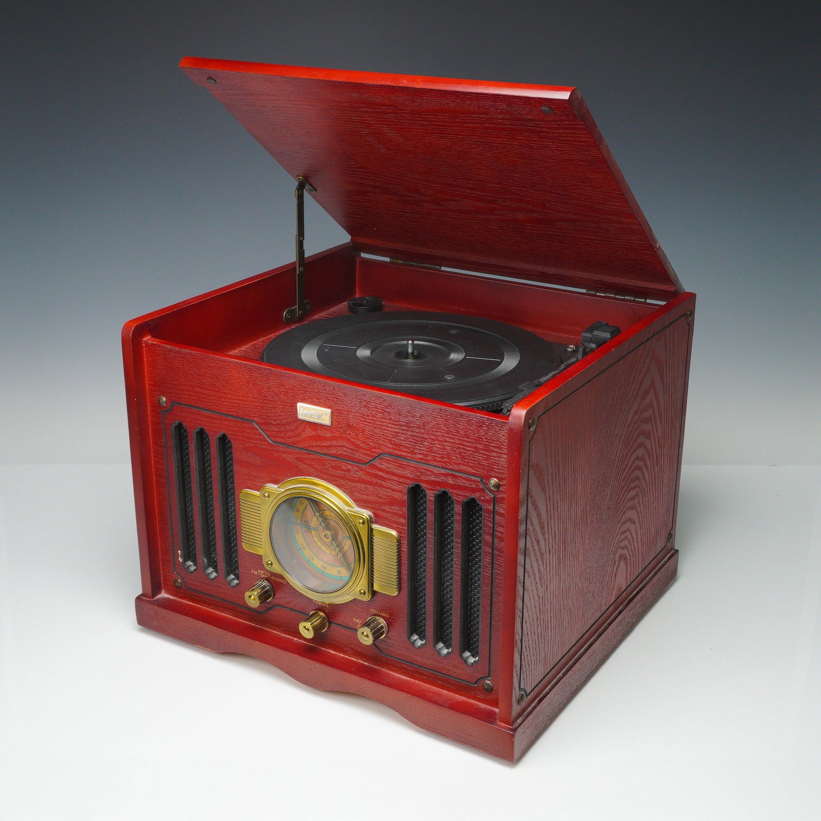 Leetac Wooden Music Center, Turntable, AM/FM Radio, and CD Player: Leetac wooden music center in a red oak finish, combining vintage charm with modern functionality. Features a three-speed belt-driven turntable beneath a hinged lid, AM/FM analog radio with a decorati