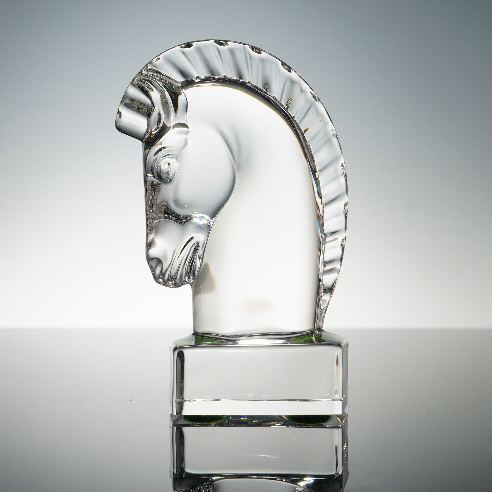 Steuben Crystal Horse Head Sculpture: Steuben crystal horse head sculpture, finely crafted with a smooth arched neck and textured mane detail, mounted on a solid rectangular base. The piece exhibits Steuben's signature clarity and brillia