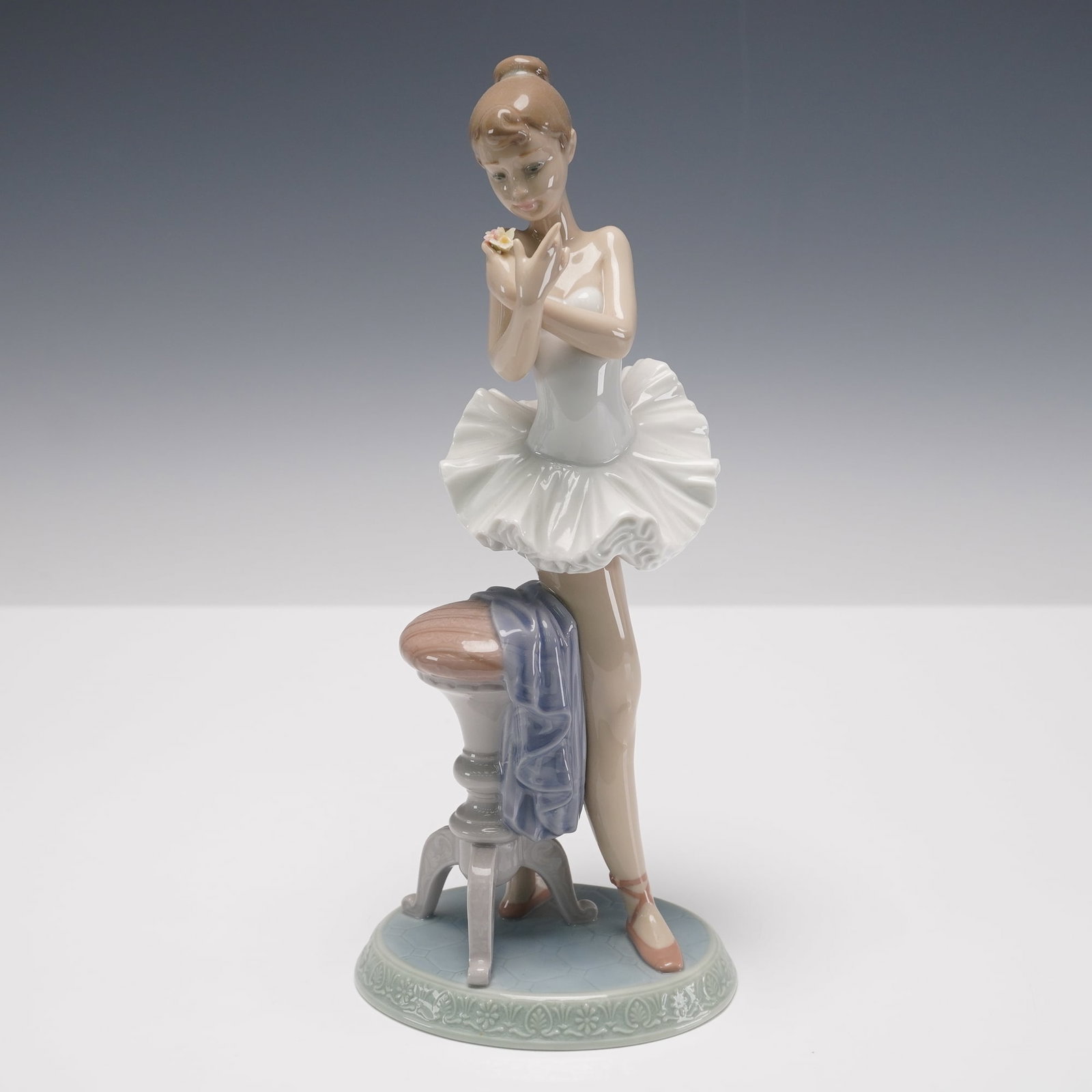 Lladro Porcelain Figurine Perfect Performance 01007641: Lladro porcelain figurine titled Perfect Performance, item number 01007641, sculpted by Regino Torrijos. This elegant 1995 Event Figurine features a young ballerina posed in a moment of reflection, dr