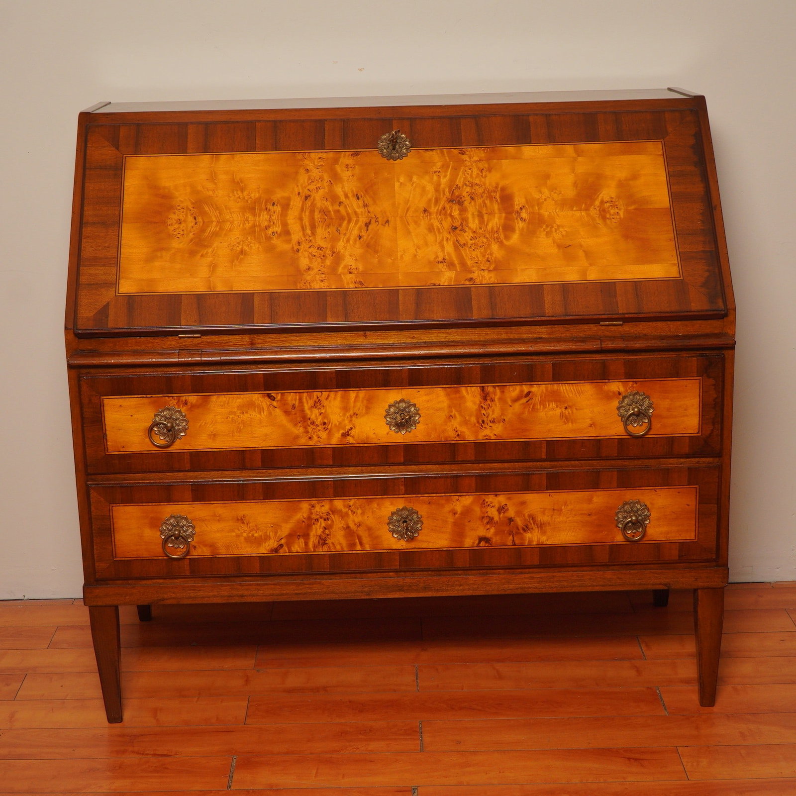 Biedermeier-Style Burl Veneer Secretary Desk: A refined Biedermeier-style secretaire crafted with light burl and crossbanded veneer panels. The fall-front writing surface folds down to reveal a fitted workspace with multiple small drawers and a c