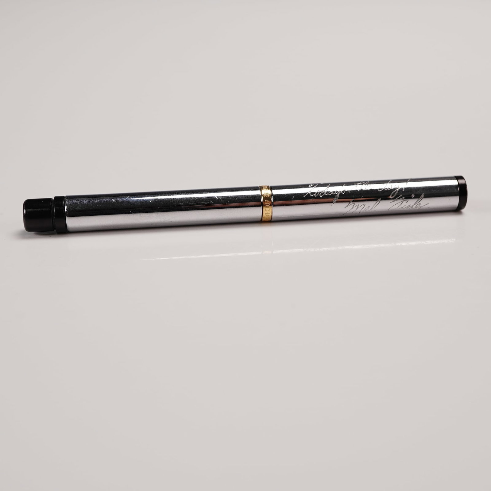 Chrome and Atocha Gold from Mel Fisher Rollerball Pen: This elegant writing instrument features a smooth rollerball tip and a screw-on cap, with a band inscribed Contains Atocha Gold, referencing the treasure recovered by famed treasure hunter Mel Fisher 