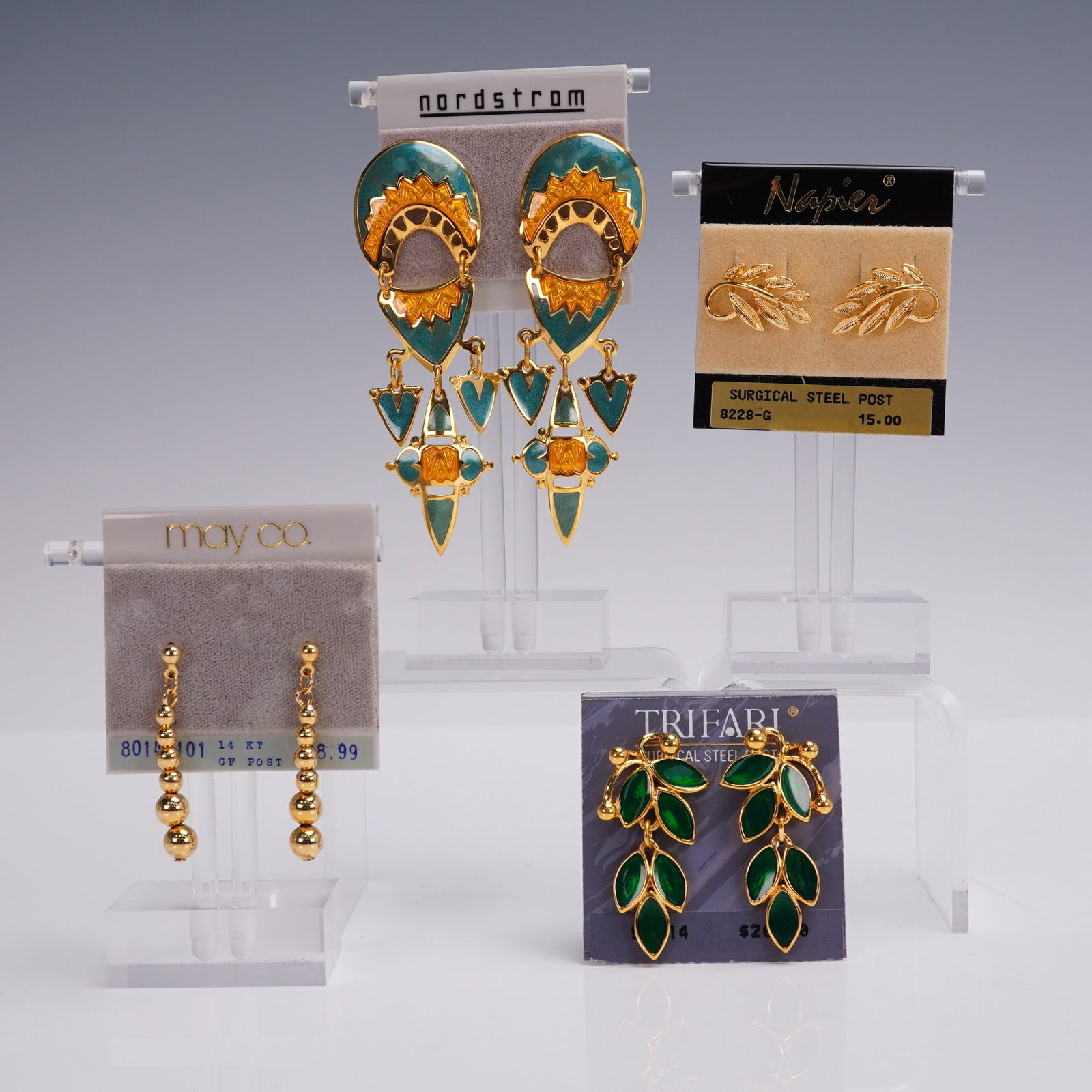 4 Pair Ladies Earring Lot incl. Trifari Napier & Nordstrom: Lot of four pairs of ladies earrings, all on original retail cards. Includes bold enamel drop earrings from Nordstrom with gold and teal tribal motifs, gold tone leaf studs marked Napier, glossy green
