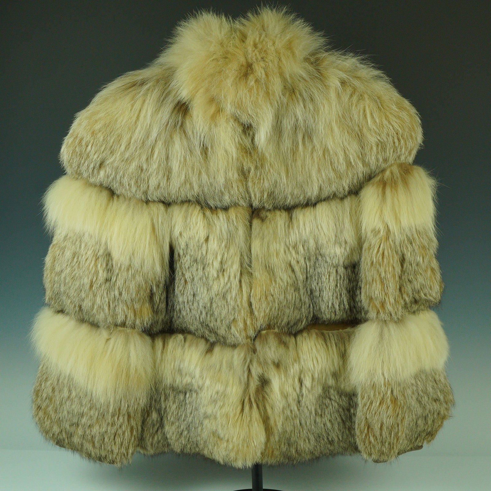Vintage Elm Fur Shoppe Tiered Fur Jacket with Patterned Lining: This dramatic vintage fur jacket from Elm Fur Shoppe, Brooklyn, N.Y., showcases a striking tiered design composed of pale golden and silvery pelts, likely fox or coyote, arranged in voluminous horizon