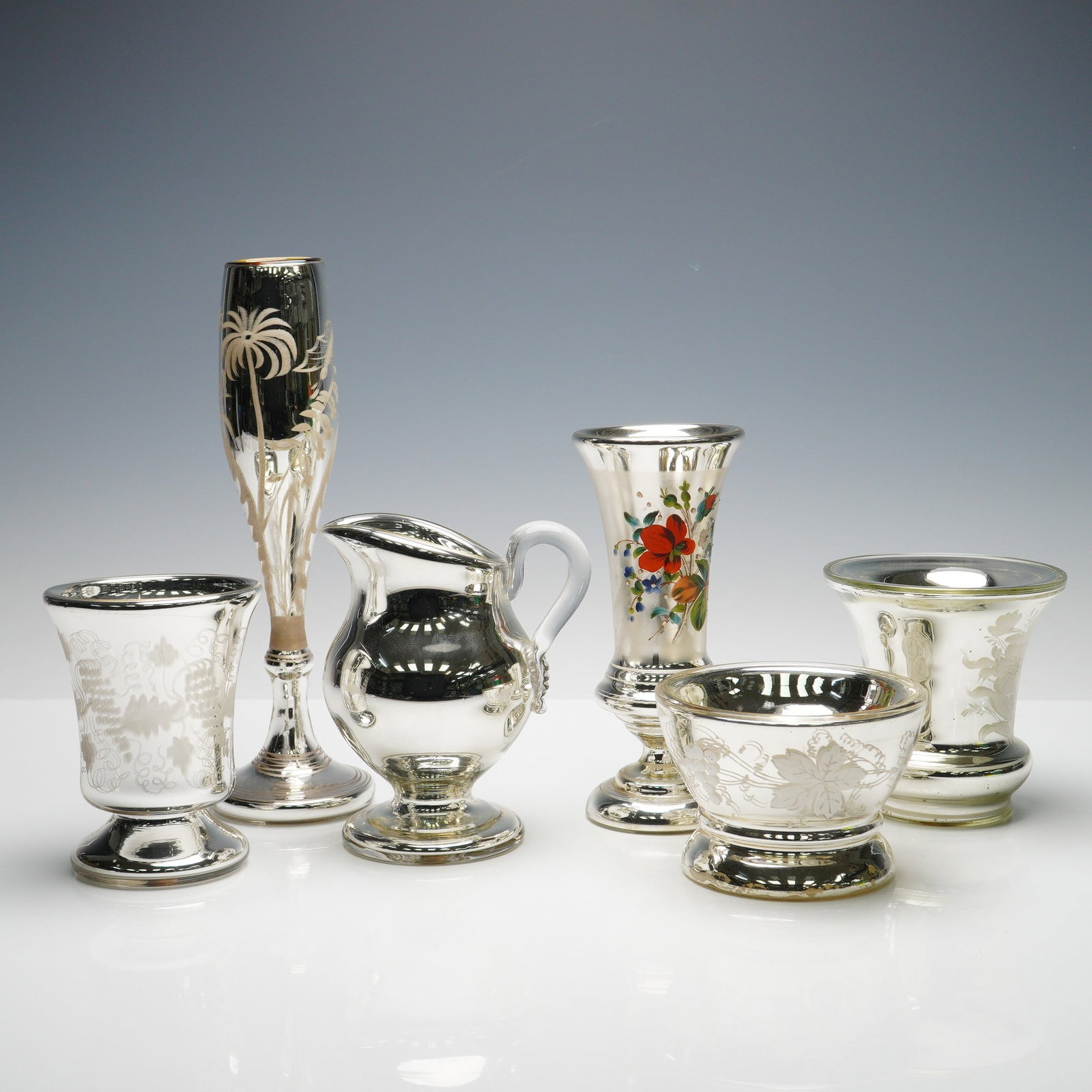 6pc Mercury Glass Silver Tableware Collectibles: An assembled group of six antique mercury glass vessels comprising various forms including two vases, a pitcher, and three footed bowls. Each crafted in double walled blown glass with silvered interio