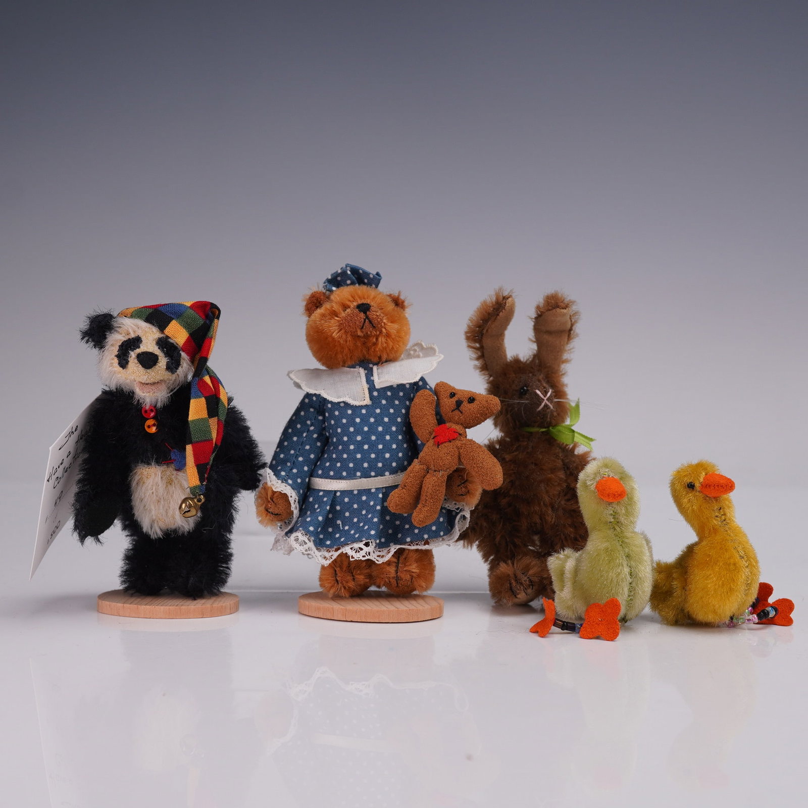 Deb Canham Animal Figurines with Boxes: Charming collection of three miniature figurines by Deb Canham Artist Designs, each crafted with meticulous detail and personality. The lot includes a black-and-white panda bear dressed in a colorful 