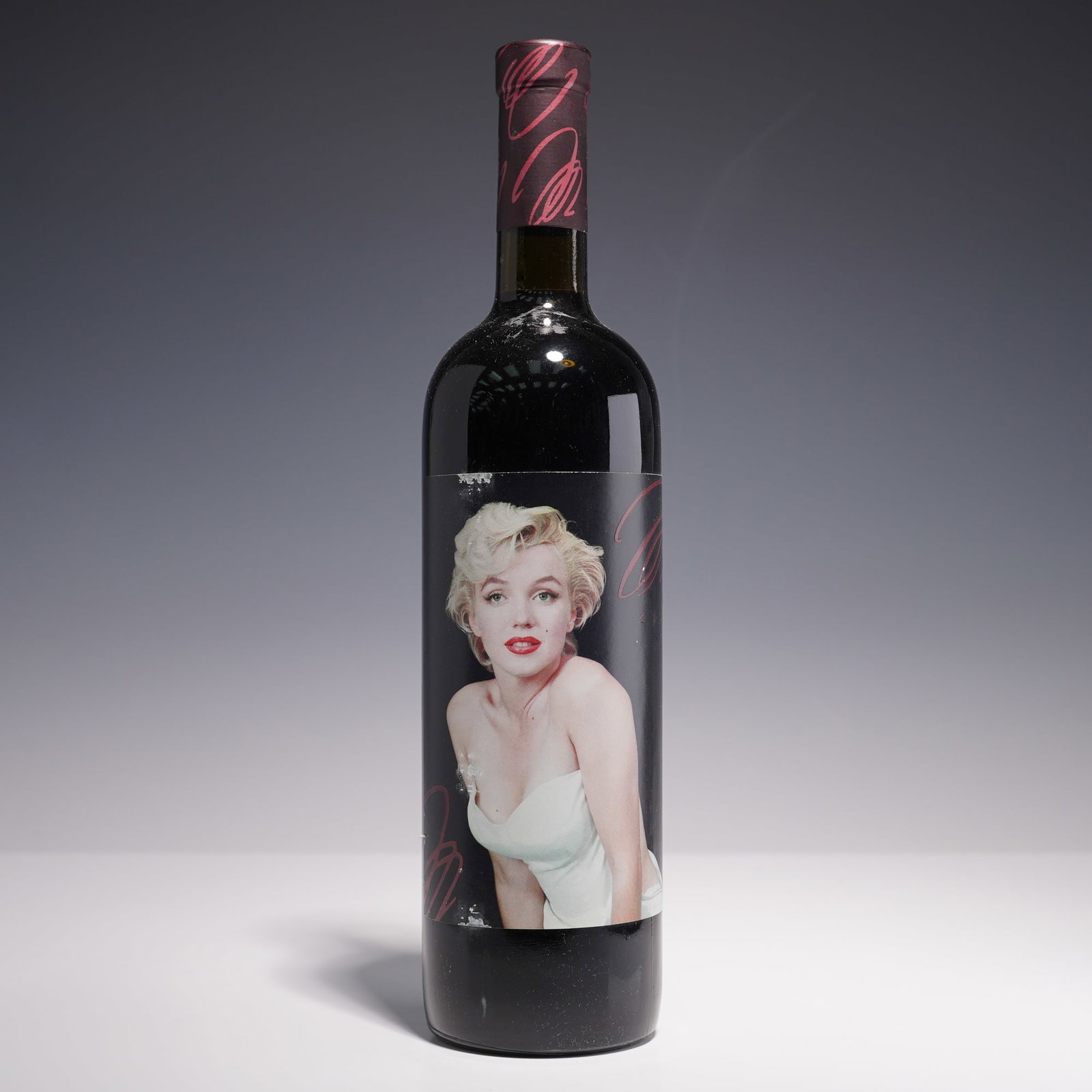 Marilyn Monroe Merlot 2000 Wine, Featuring Studio Portrait: This 750 ml bottle of 2000 Marilyn Merlot from Oakville's Nova Wines features a radiant studio image of Marilyn Monroe, dressed in a pale white gown with classic platinum curls and red lipstick. The d