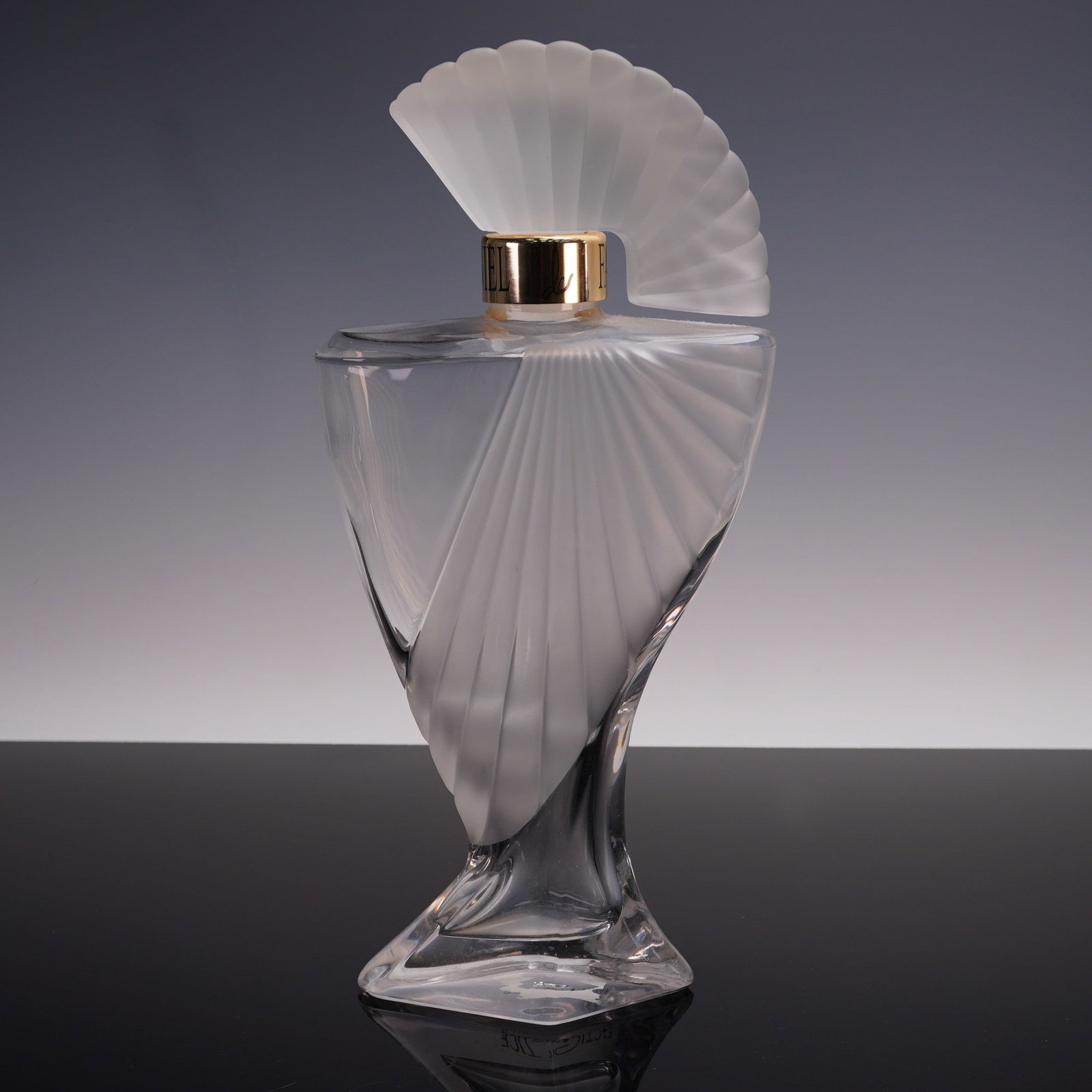 Daniel de Fasson Large Factice Perfume Bottle: Large display factice perfume bottle for Daniel de Fasson, featuring an elegant sculptural glass form with frosted fan-shaped accents and a twisted base. The bottle is topped with a matching frosted g