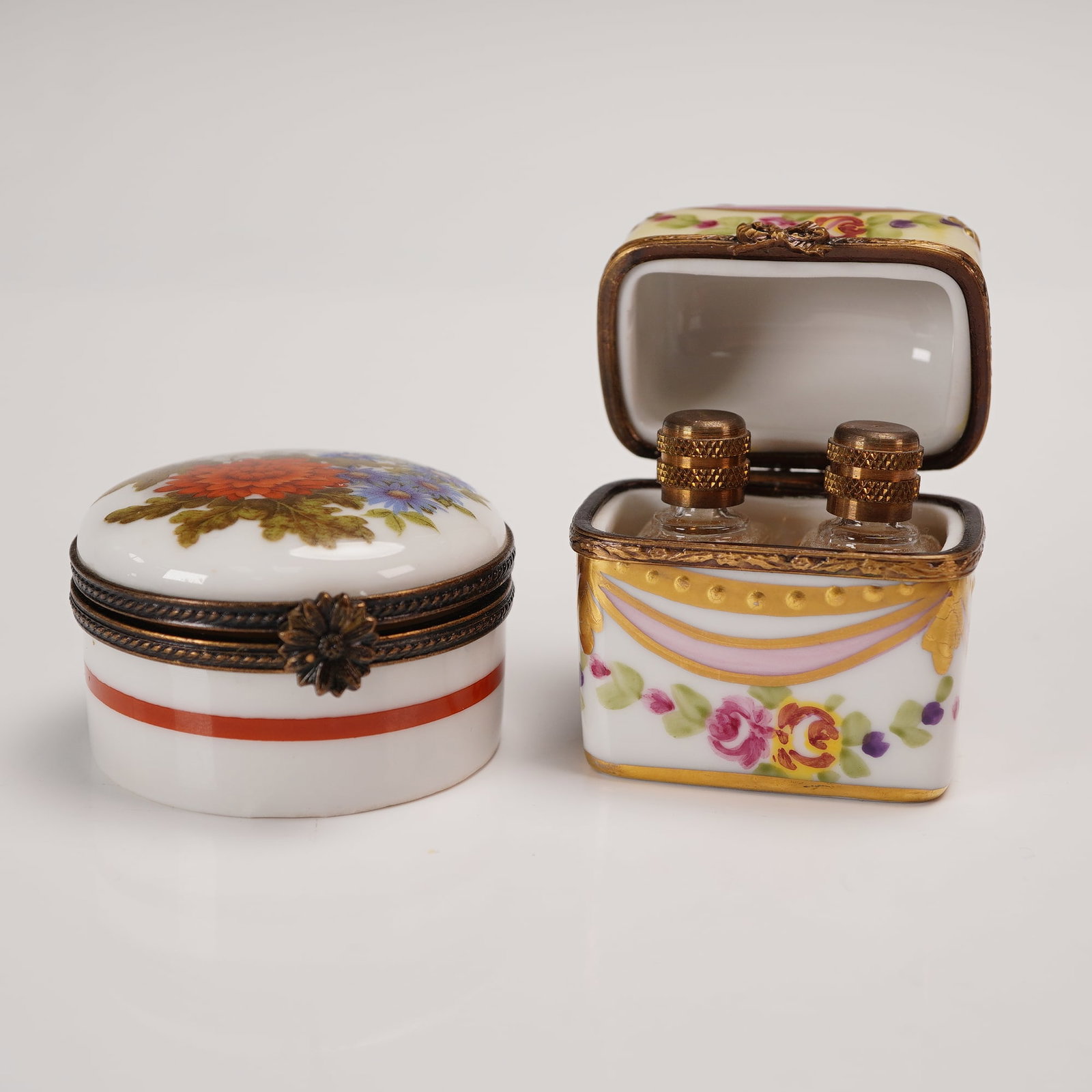 4pc Limoges Porcelain Trinket Box Set with Perfume Bottles: Delightful set of two hand-painted Limoges porcelain trinket boxes, one round with floral motif and the other square-form with garland design and hinged lid opening to reveal two miniature glass perfu