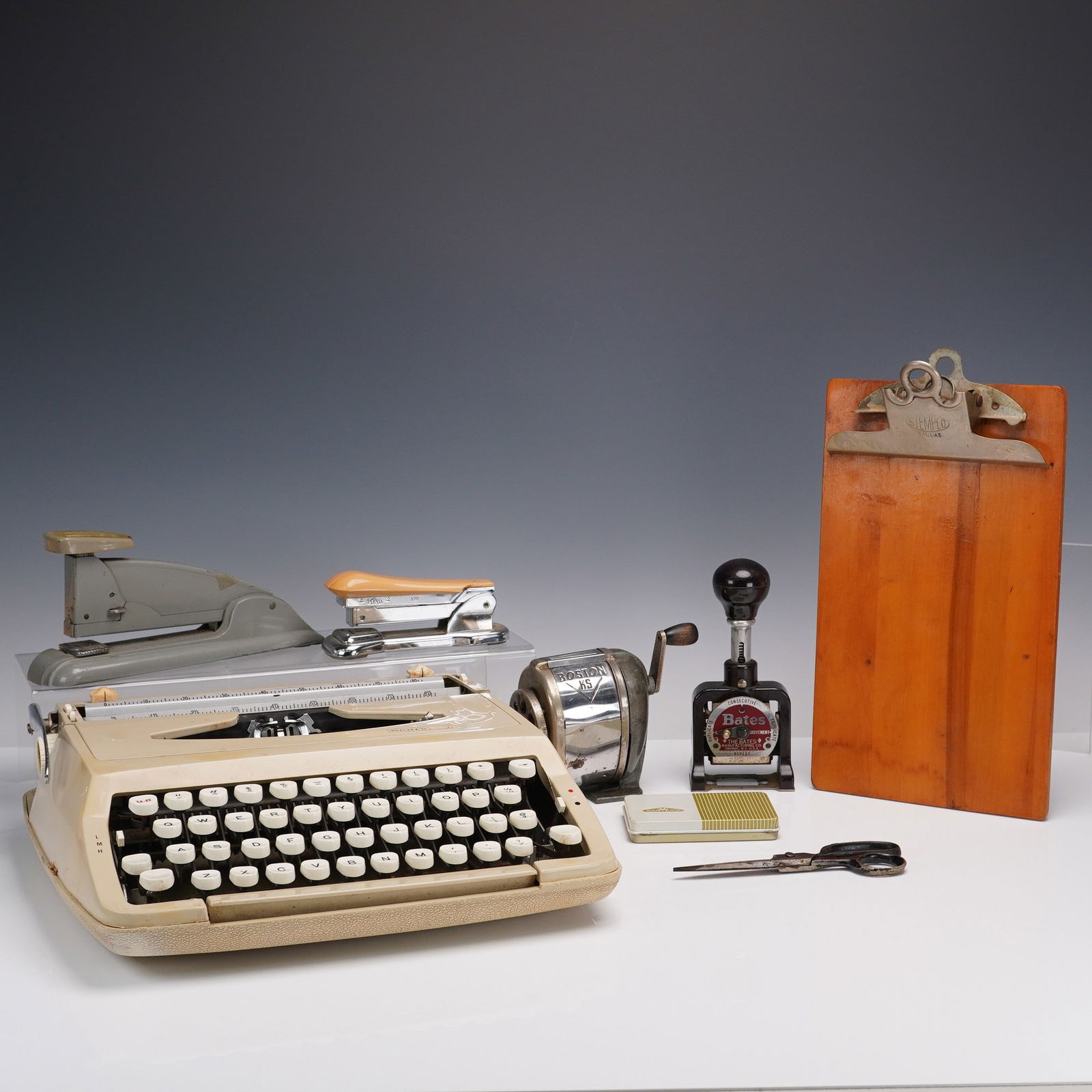 8pc Vintage Office Set with Sears Scout Typewriter: A nostalgic ensemble of vintage office essentials featuring a Sears Scout manual typewriter, model 871-1920, made in England and distributed by Sears, Roebuck and Co. The compact typewriter comes in i