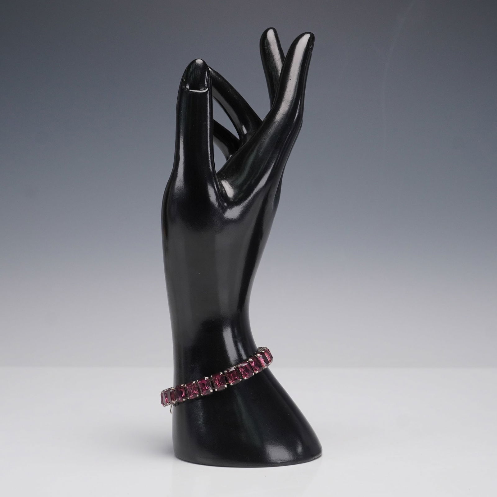 Sterling Silver Bracelet with Rectangular Purple Stones: This elegant sterling silver bracelet features a series of rectangular purple stones set in a sleek, linked design. The bracelet is marked "STERLING" on the clasp, signifying its authenticity and supe