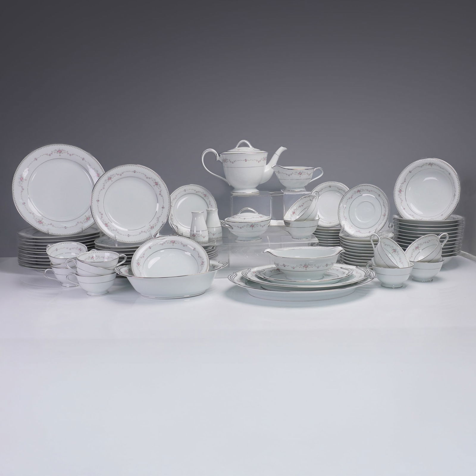 94pc Noritake Fairmont Dinnerware Set, Service for 12: An elegant 94-piece porcelain dinnerware set by Noritake in the delicate and discontinued Fairmont pattern, number 6102. This full service for twelve showcases fine white china accented by soft floral