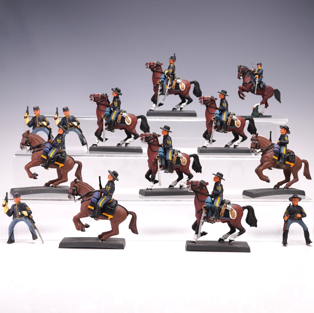 13pc US 7th Regiment Cavalryman Figures: Set of 13 hand-painted metal figures depicting mounted and dismounted US 7th Regiment Cavalrymen, marked "USA 1876" and manufactured by DEE by Cassandra. Each figure is finely detailed in historically