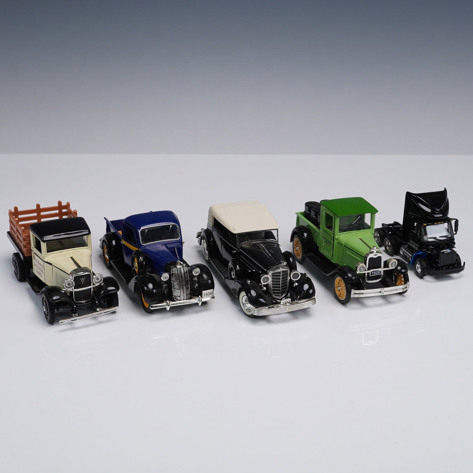 5pc Vintage Die Cast Toy Truck Lot Mixed Styles: Five piece lot of vintage-style die cast toy trucks including pickup beds, flatbeds, and early model truck cabs. Designs include painted sponsor details such as New Haven Salvage and model markings li