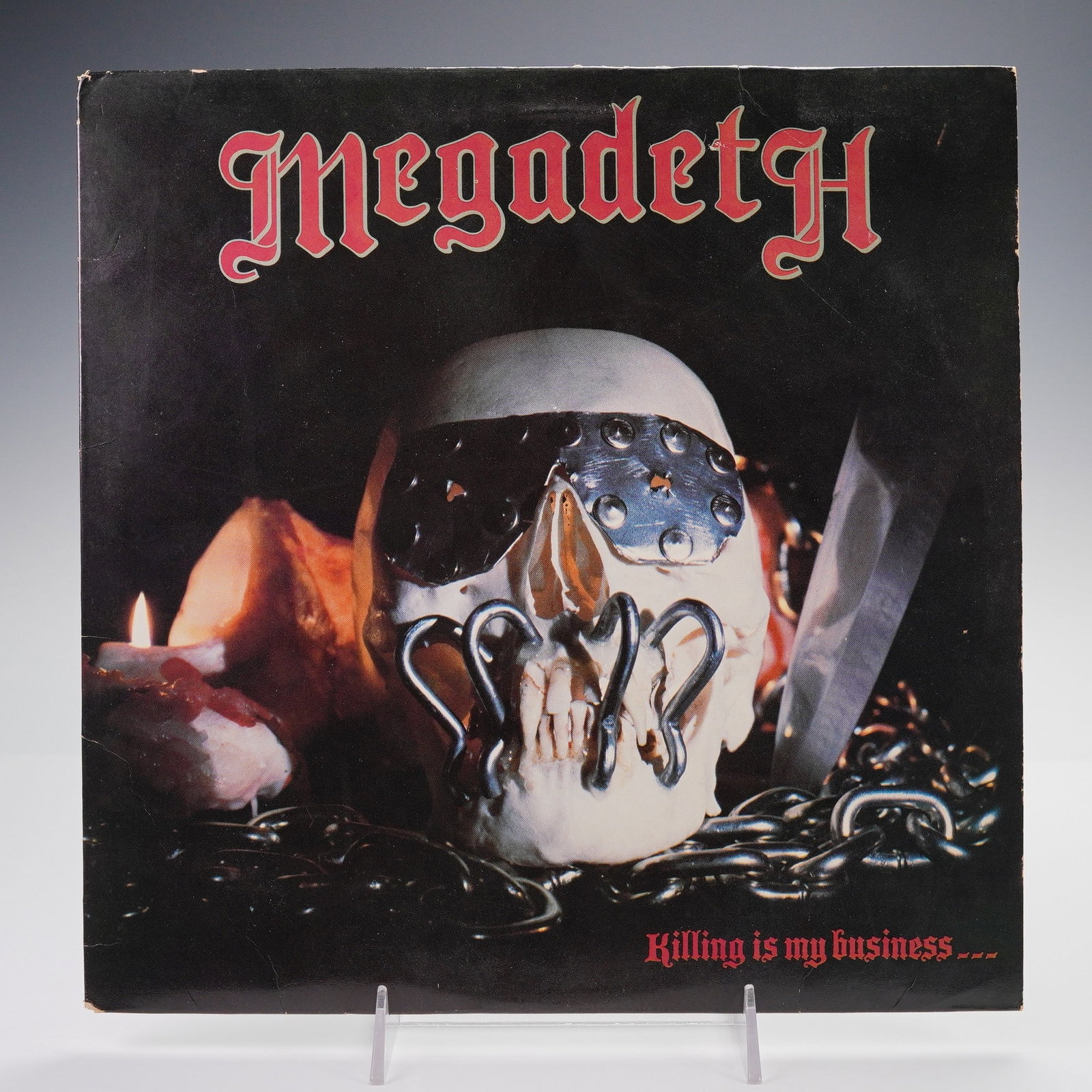 Combat Records Megadeth Vinyl Record, Killing is My Business: A 1985 U.S. first pressing of Killing Is My Business... And Business Is Good!. This 33 RPM LP features the original uncensored artwork showcasing a chained skull and includes 8 tracks, among them "Rat