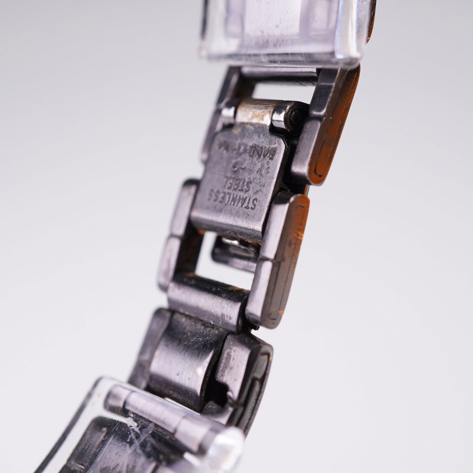 Pulsar Solar Wristwatch Black and Gold Tone: Ladies' Pulsar Solar wristwatch featuring a round black face with gold-tone hour markers and hands, including Roman numeral XII and a date window at the 3 o'clock position. The black and gold-tone lin