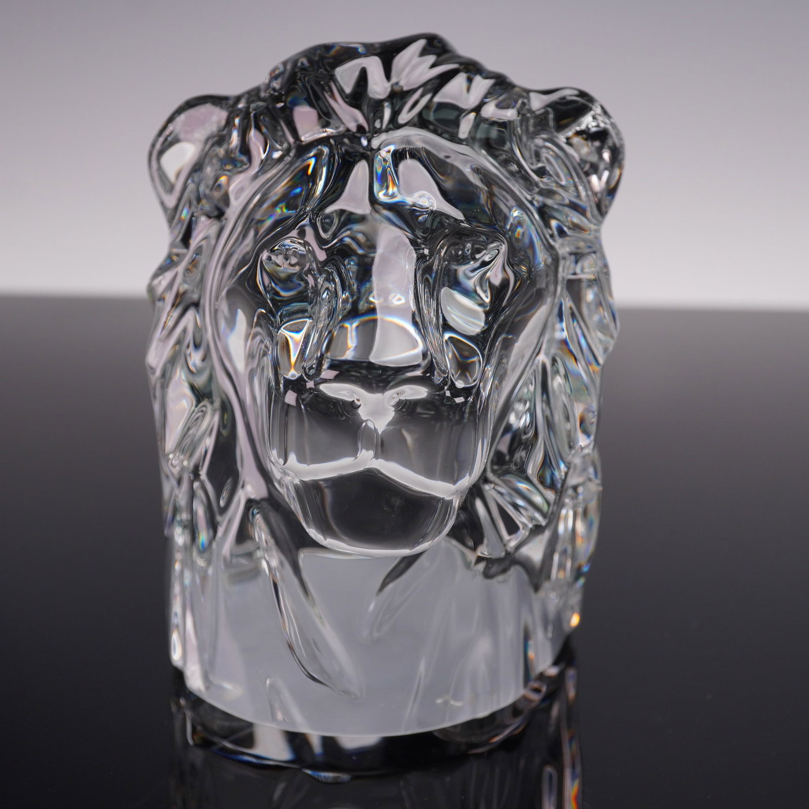 Baccarat Crystal Lion Head Sculpture: Bold clear crystal lion head sculpture with faceted details and a powerful silhouette. The stylized mane and expressive face capture the regal essence of the lion, while the facial features are render