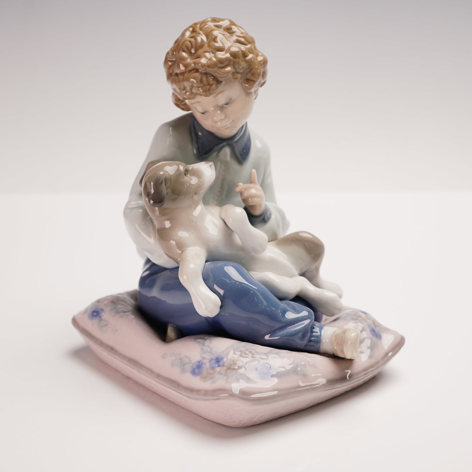 Lladro Porcelain Figurine, Behave! 01005703: Charming Lladro porcelain figurine titled Behave! (Spanish: Portate Bien!), model number 5703, designed by Antonio Ramos. This endearing figural composition captures a curly-haired boy gently scolding