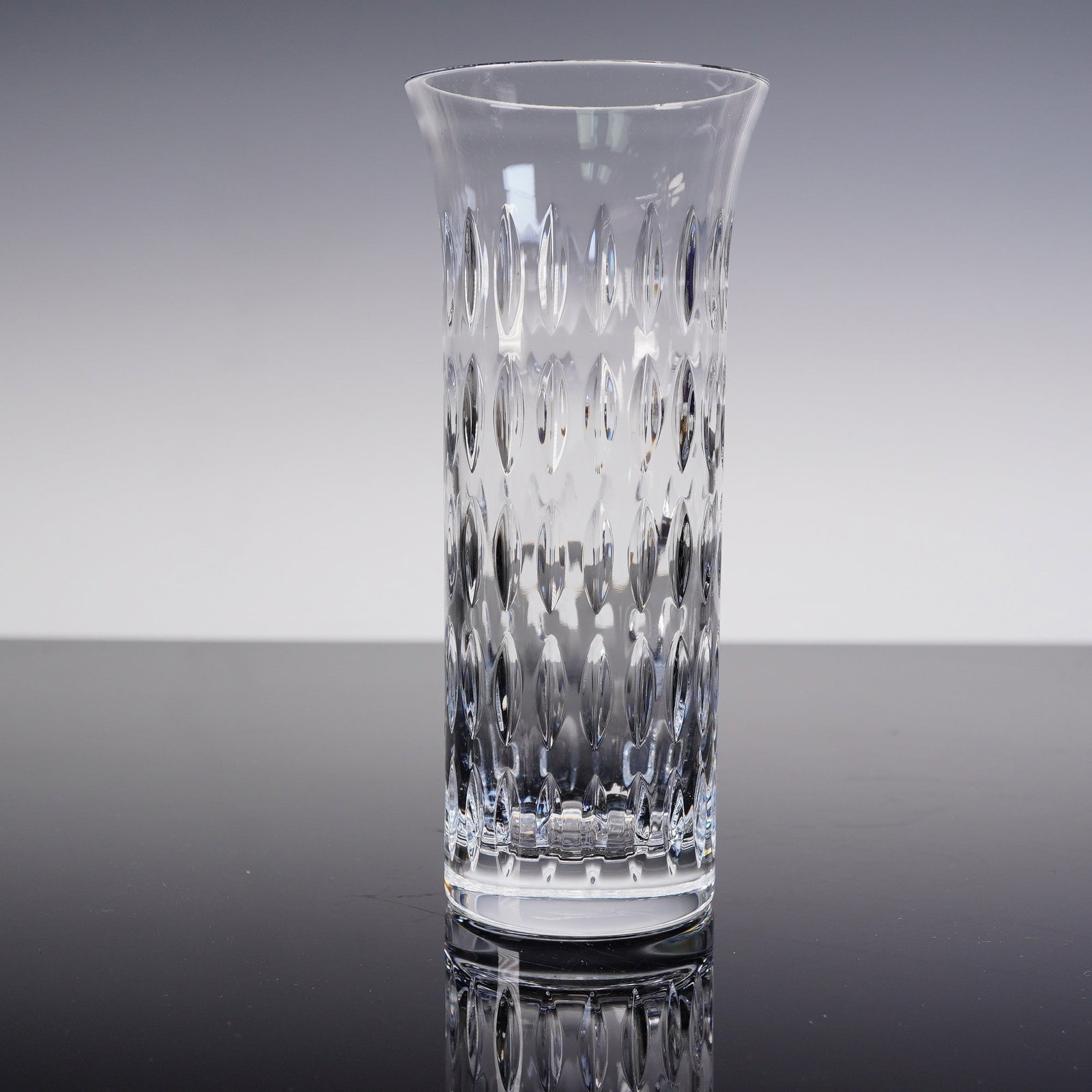 Baccarat Crystal Flora Grain De Riz Vase: Baccarat crystal Flora Grain De Riz vase featuring a flared rim and an elegant rice grain-inspired cut pattern that reflects light beautifully. Etched with the Baccarat France hallmark and Baccarat si