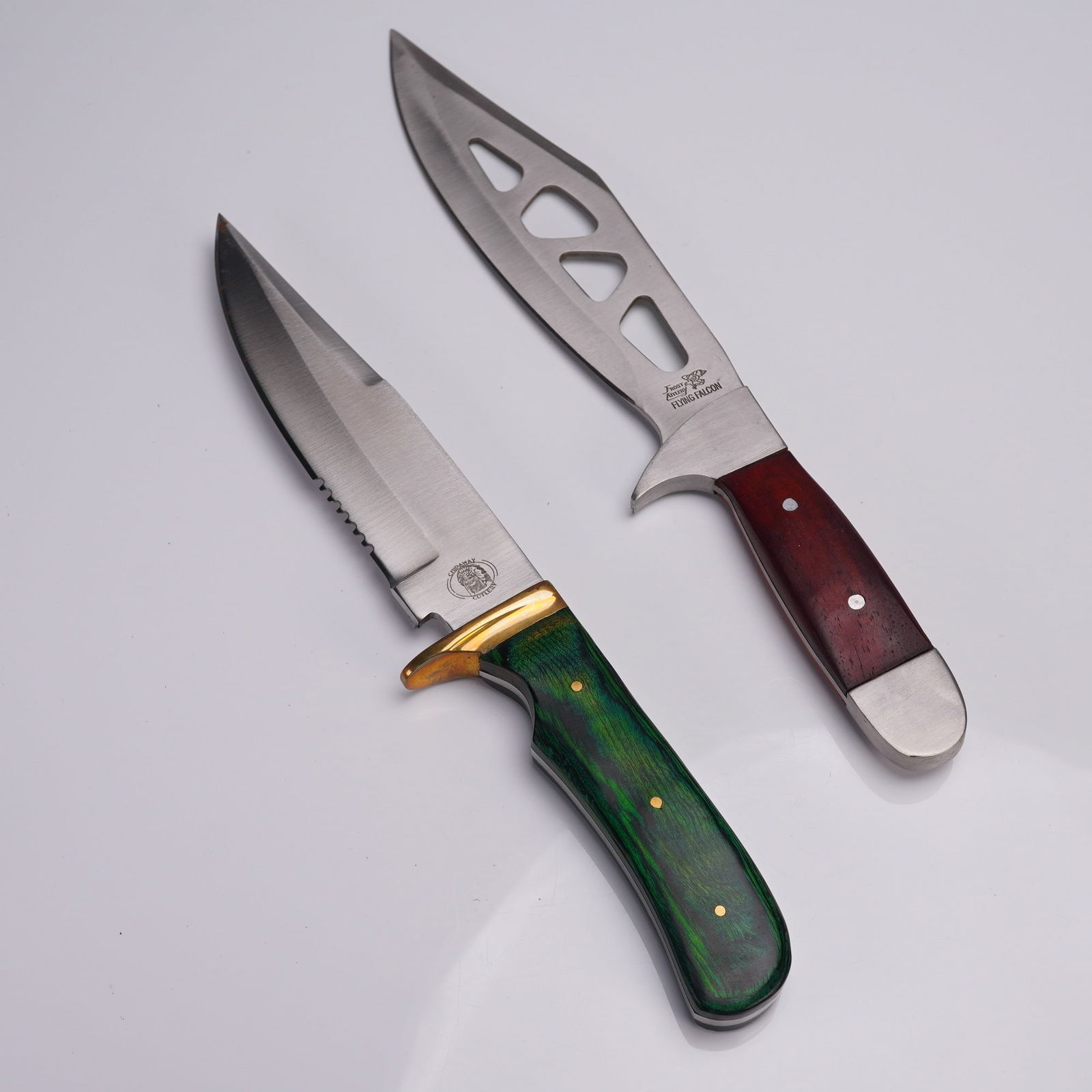 2pc Fixed Blade Bowie Knives, Frost Cutlery and Chipaway Cutlery: Set of two fixed-blade hunting knives, each presented in its original retail box and accompanied by a black leather sheath. The first knife is the Frost Cutlery Flying Falcon Trailblazer model 15-185