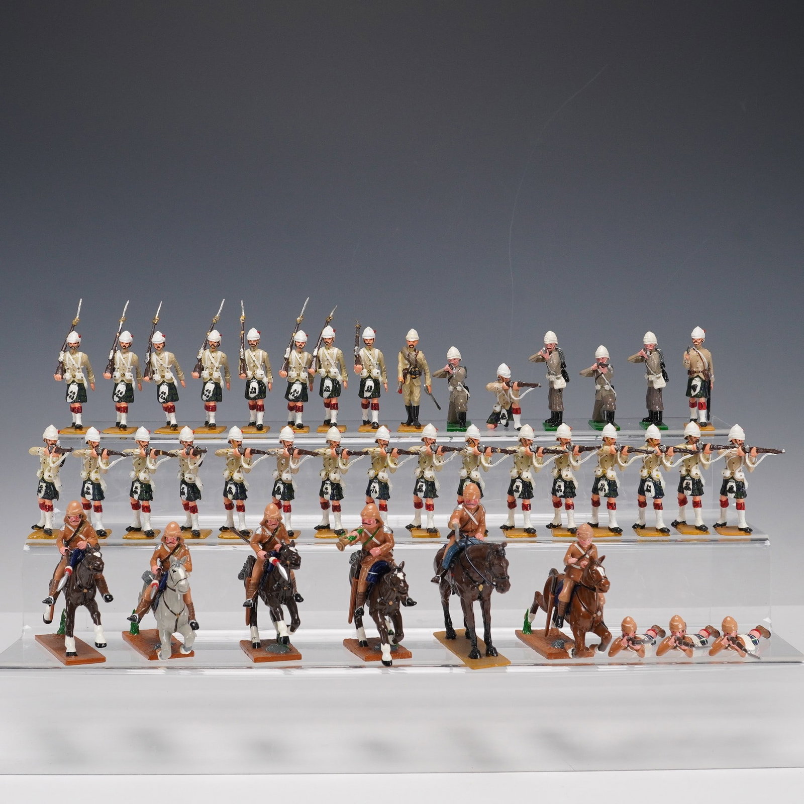 40pc Military-Style Toy Soldiers, Highland and Colonial Types: Large 40-piece set of hand-painted cast metal military-style figurines modeled in the tradition of late 19th-century uniforms. Includes soldiers in pith helmets, khaki service dress, and Highland regi