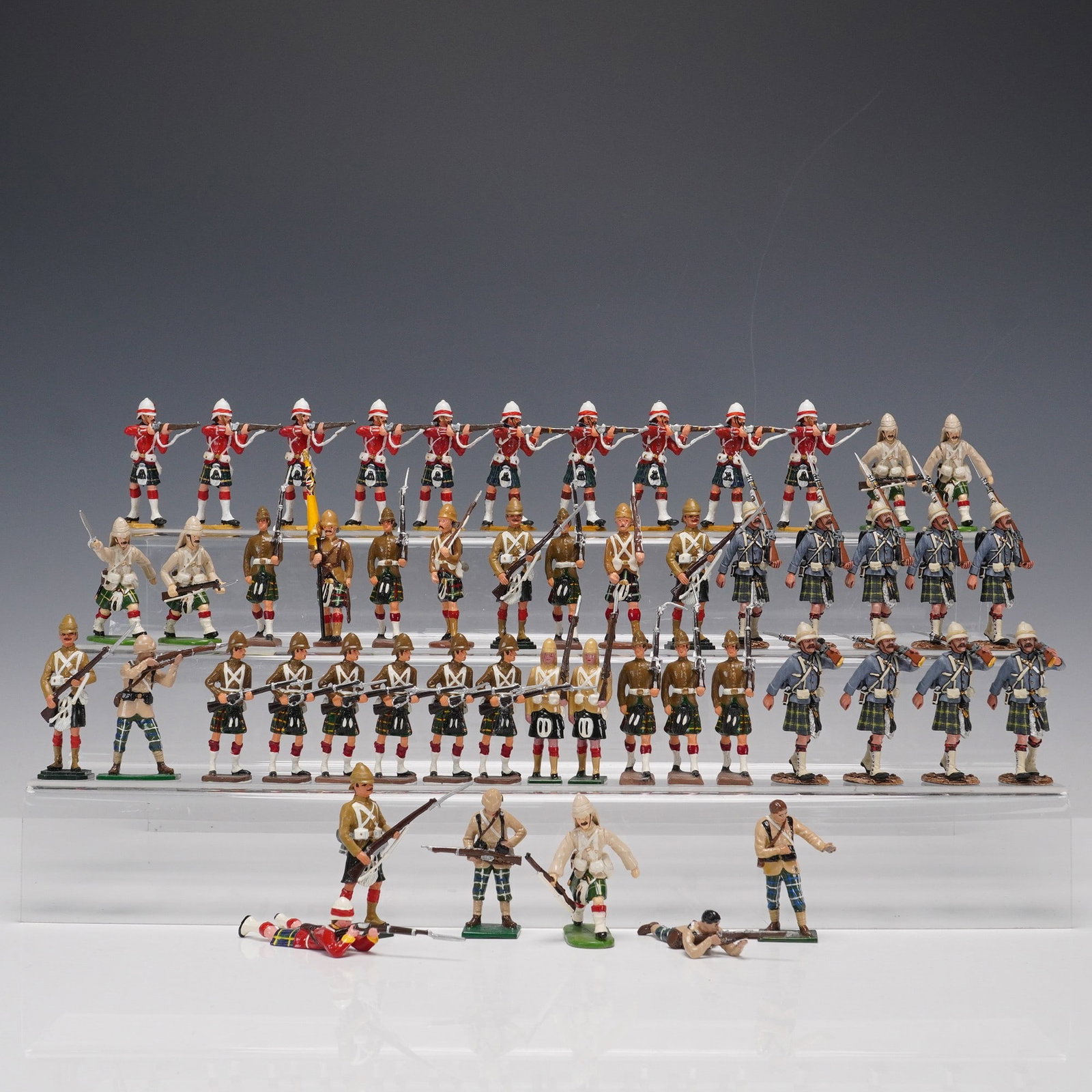 48pc Lot of Military Highlander Toy Soldiers by C.M., JJ Designs & El Temp.: A 48-piece collection of hand-painted military Highlander toy soldiers representing various British regiments, primarily outfitted in 19th century campaign uniforms with kilts and pith helmets. The lo