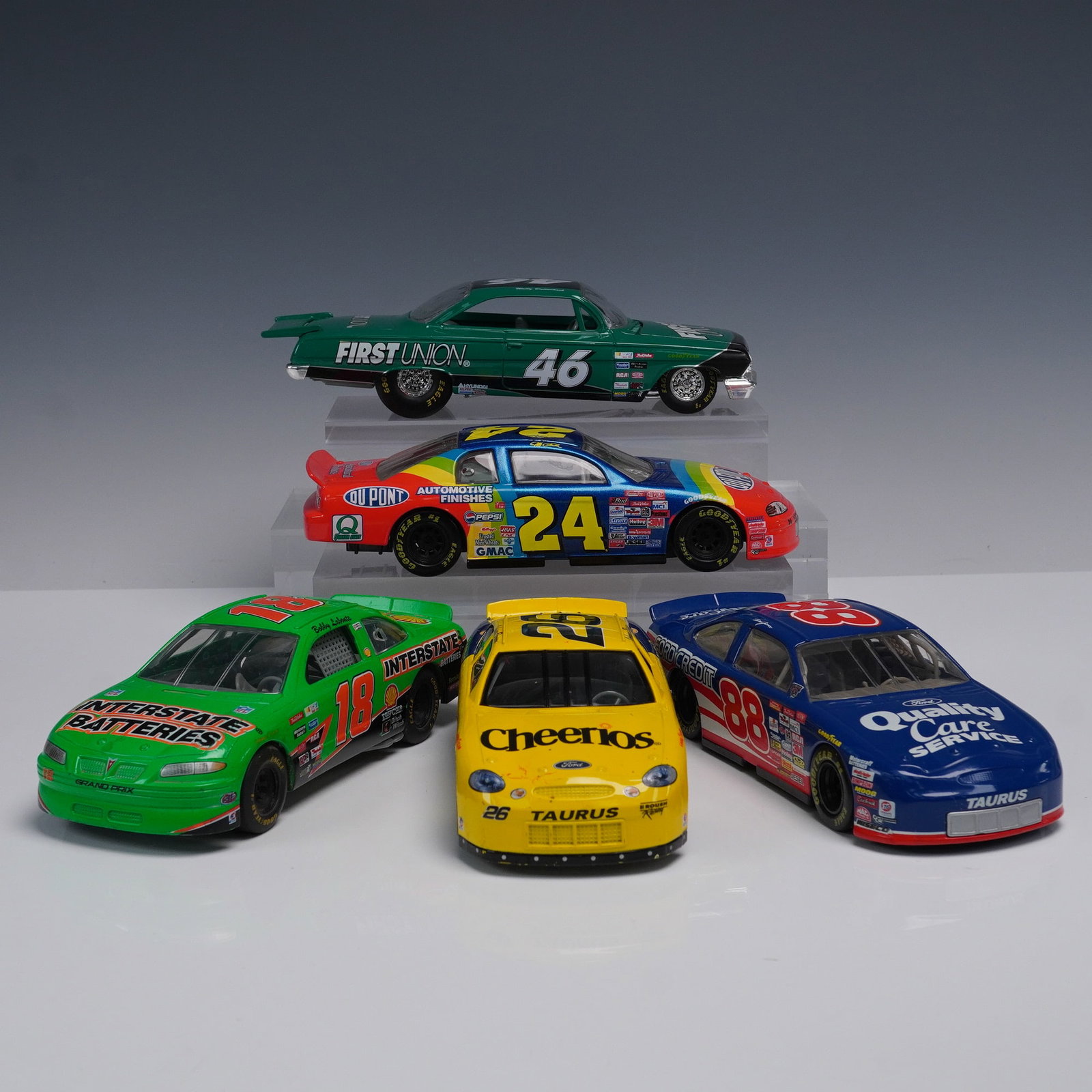 5pc NASCAR Die Cast Race Car Replica Collection: An assorted group of five 1:24 scale die-cast model NASCAR vehicles featuring liveried designs from notable sponsors and teams, each detailed with manufacturer specific body styles and authentic spons