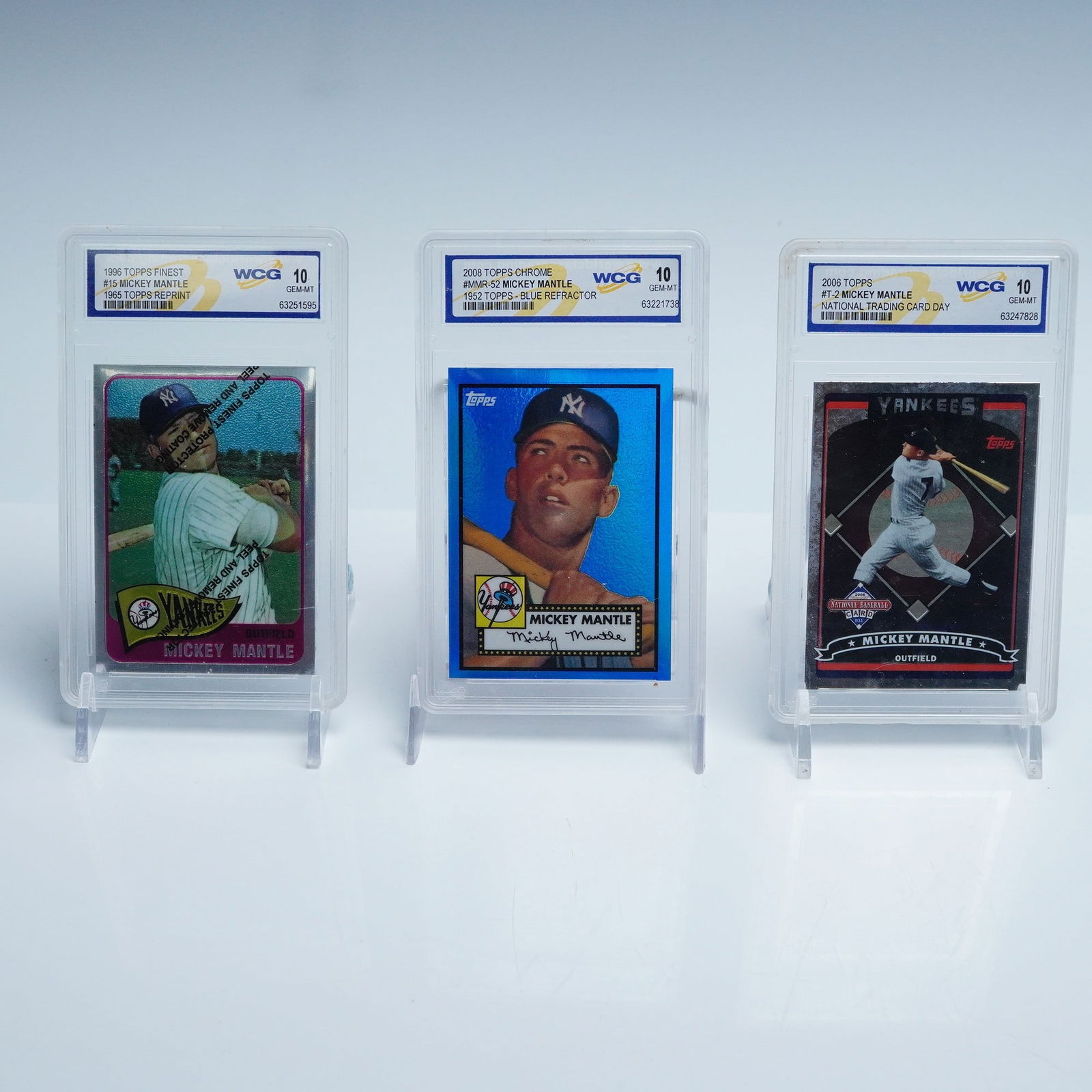 3 Mickey Mantle Yankees Commemorative Cards WCG 10: Set of three commemorative Mickey Mantle baseball cards by Topps, each celebrating the iconic New York Yankees outfielder and slabbed in hard plastic holders with WCG 10 Gem Mint grading. This lot inc