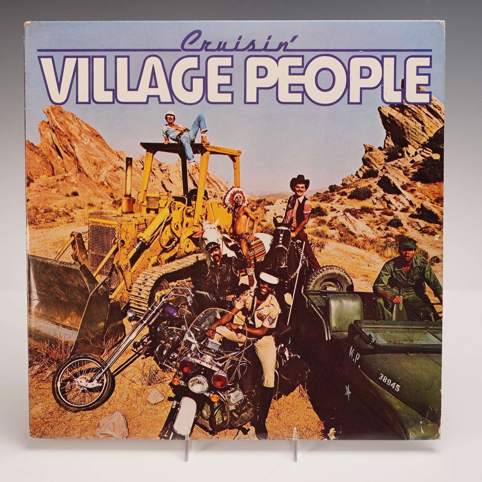 Casablanca Records Village People Vinyl Record, Cruisin: An original 1978 pressing of the Village People's landmark album "Cruisin' ", released by Casablanca Records. The front cover depicts the band members in full regalia, posed amidst heavy machinery and
