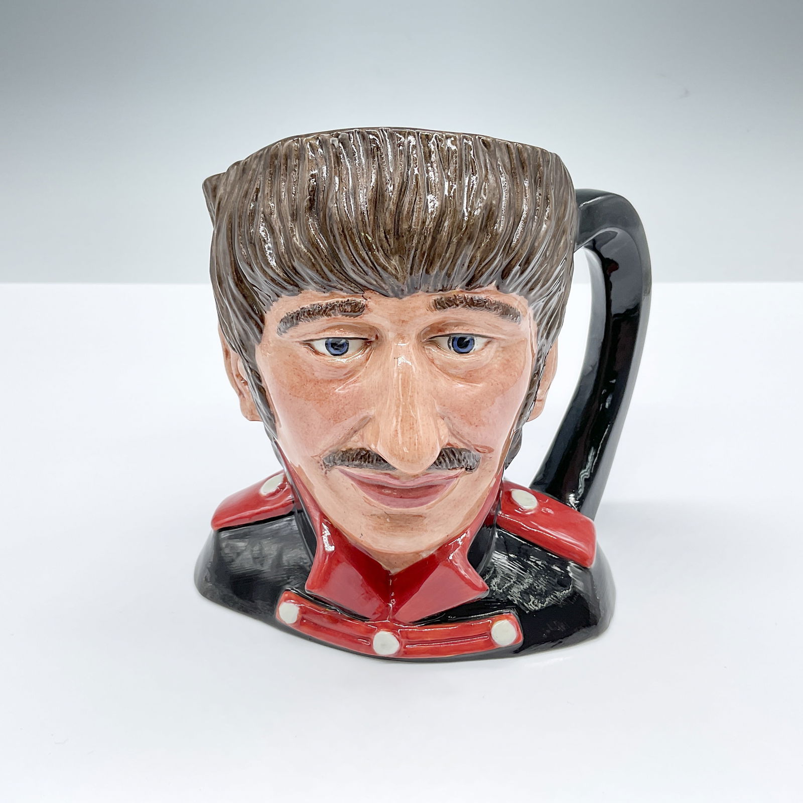 Royal Doulton Prototype Colourway Character Jug, Ringo Starr: Rare colorway variation for the Beatles series. Black jacket with red collar and epaulettes. Plain dark handle. Royal Doulton backstamp. Marked: The Property Of Royal Doulton Tableware LTD., Not Produ