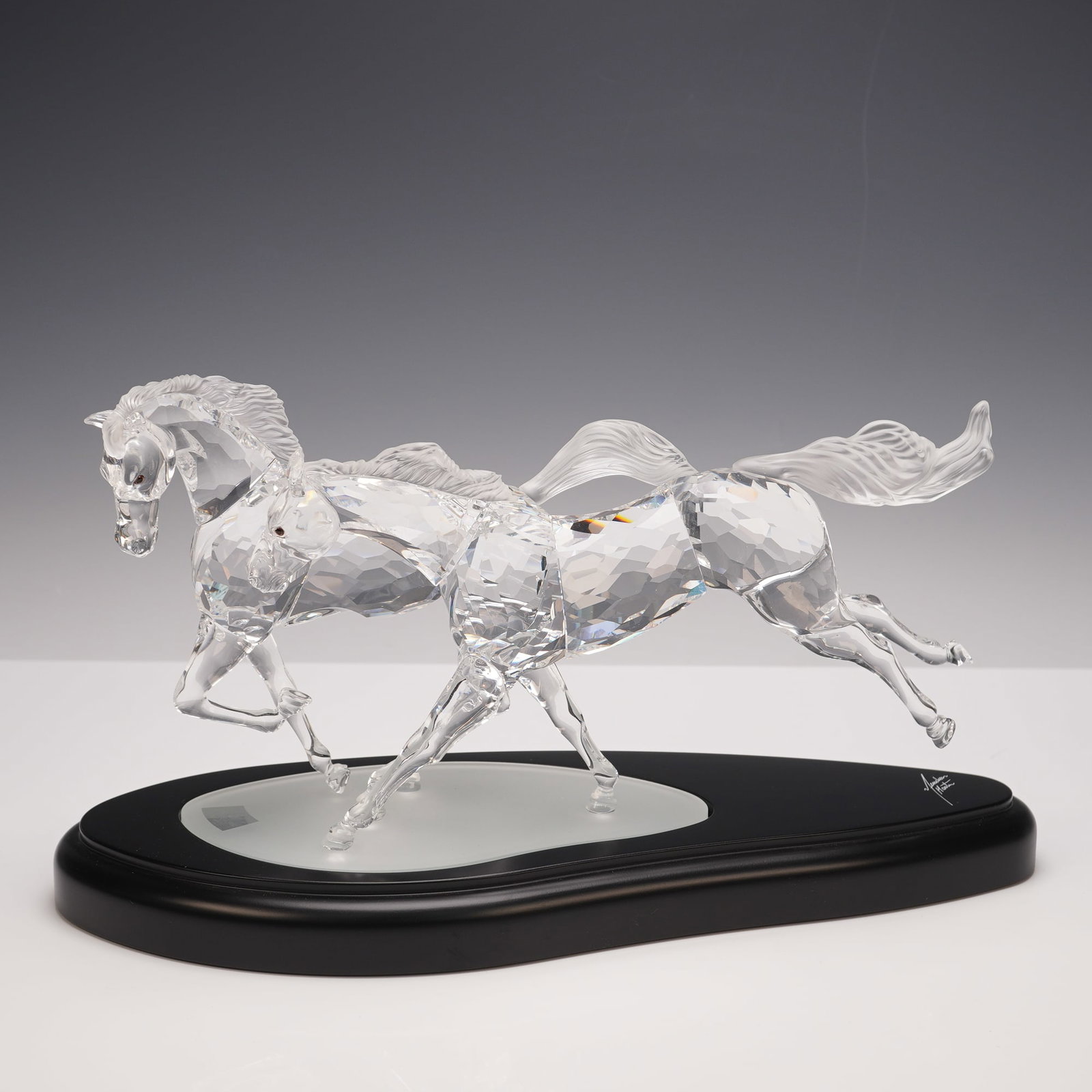 Swarovski Crystal Figurine + Base, Wild Horses: A captivating Swarovski crystal sculpture titled Wild Horses, designed by Martin Zendron, showcasing two galloping horses captured in mid-stride. Expertly crafted in faceted clear crystal, the pair ra