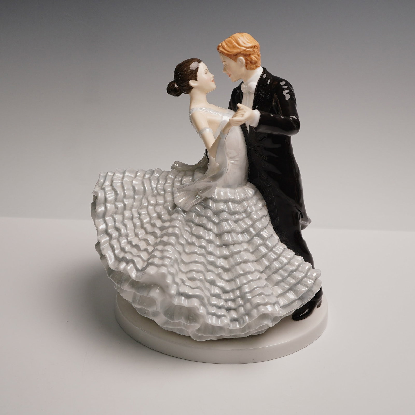 Royal Doulton Dance Figurine, The Slow Waltz HN5444: Limited edition, handmade, and hand-decorated bone china figurine from Royal Doulton's Dance Collection, depicting a formally dressed couple engaged in a slow waltz. The male figure wears a black tail
