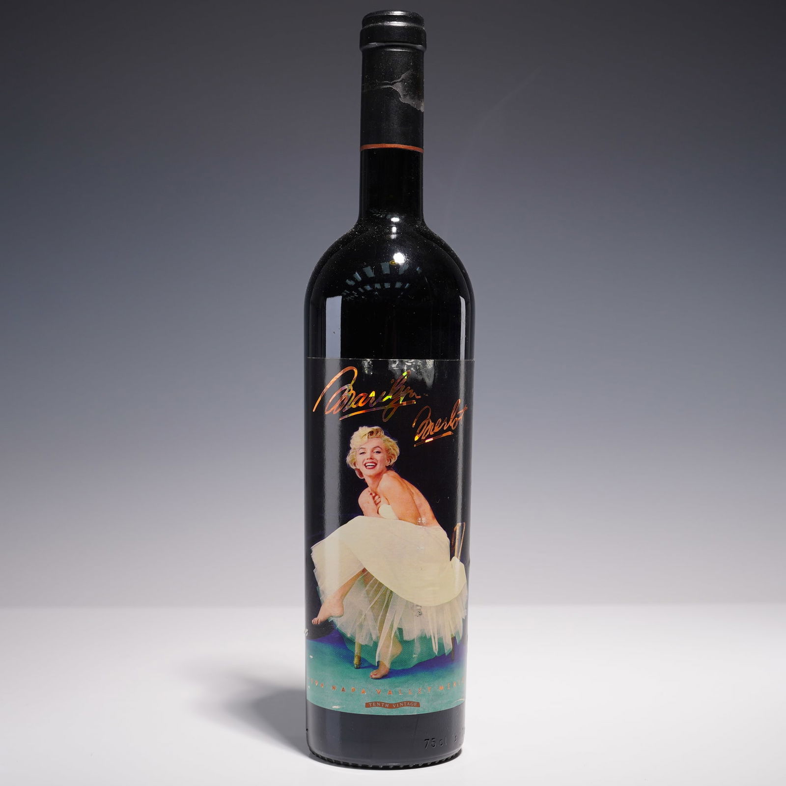 1994 Marilyn Merlot, 750ml Wine Bottle: A collectible 750ml bottle of 1994 Marilyn Merlot wine featuring a vibrant label adorned with an iconic image of Marilyn Monroe in her famous white dress pose. The bottle is sealed with a unique cap e