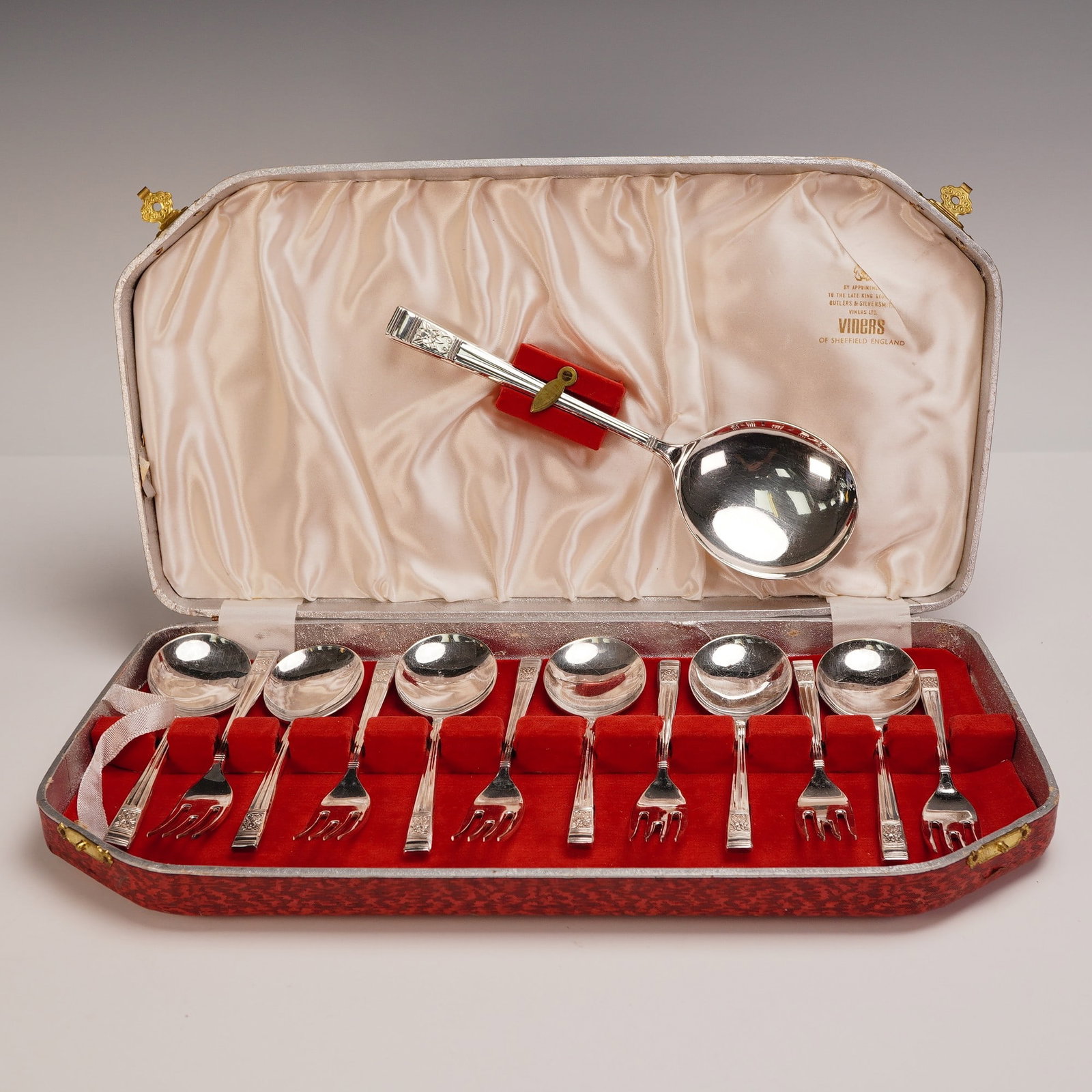 13pc Vintage Viners of Sheffield Silverplated Dessert Set in Fitted Case: A 13-piece silverplated dessert set by Viners Ltd. of Sheffield, England, housed in its original red-patterned fitted case with satin and velvet lining. The set comprises six dessert forks, six desser