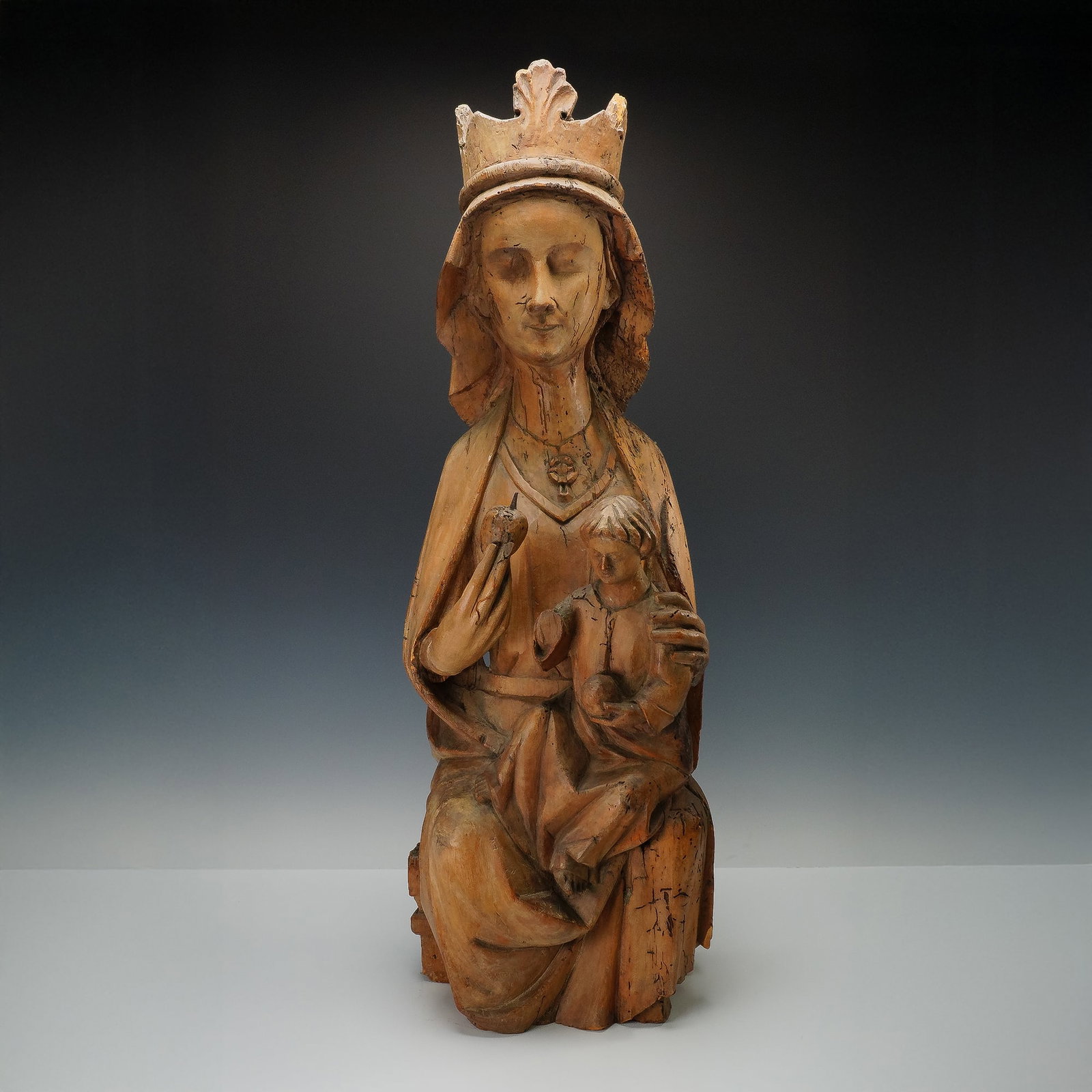 14th Century French Gothic Madonna and Child Carved Wood Sculpture: Late 14th century Gothic polychrome wood sculpture of the Madonna and Child in Majesty, attributed to the Ile de France School, a leading artistic tradition centered around Paris from the late 12th to