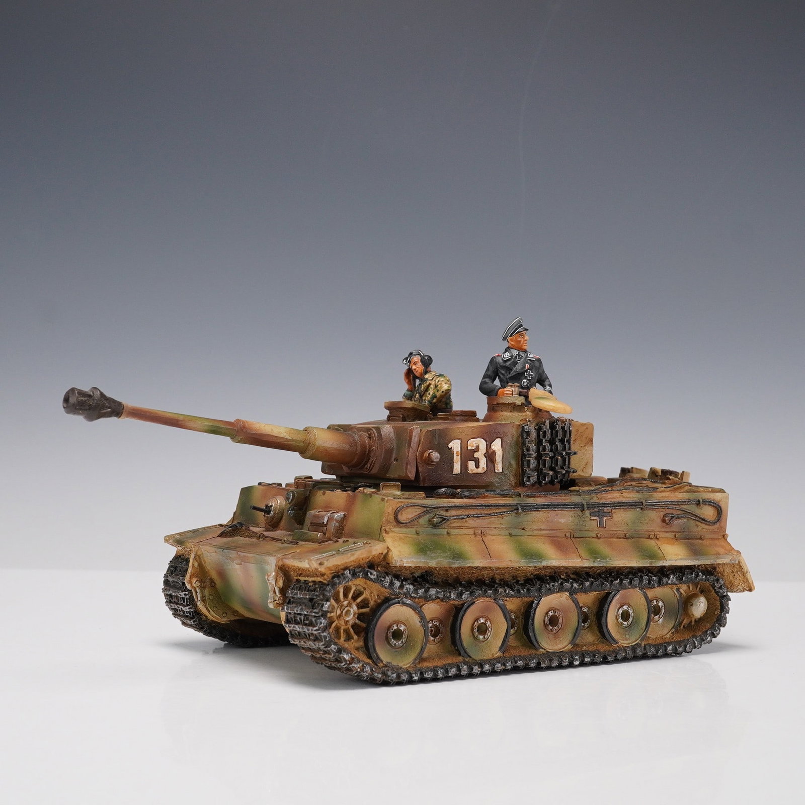 King & Country Tiger Tank Figurine, 131 Camouflage: Highly detailed King & Country WWII Tiger tank figurine featuring a camouflage finish and numbered 131 on the turret. The tank is manned by two removable crew figures painted in historically inspired 