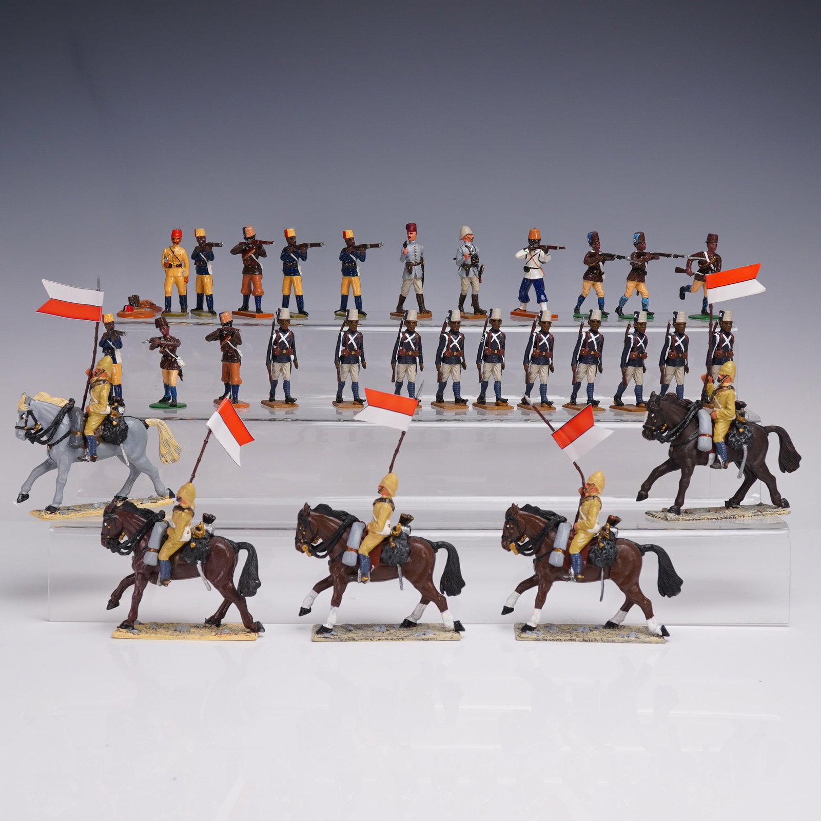 30pc El Templario Colonial Toy Soldier Figure Set: Lot of 30 hand-painted metal figures by El Templario representing colonial-era infantry and cavalry soldiers. The set includes marching and firing riflemen in blue coats and tan trousers, cavalrymen i