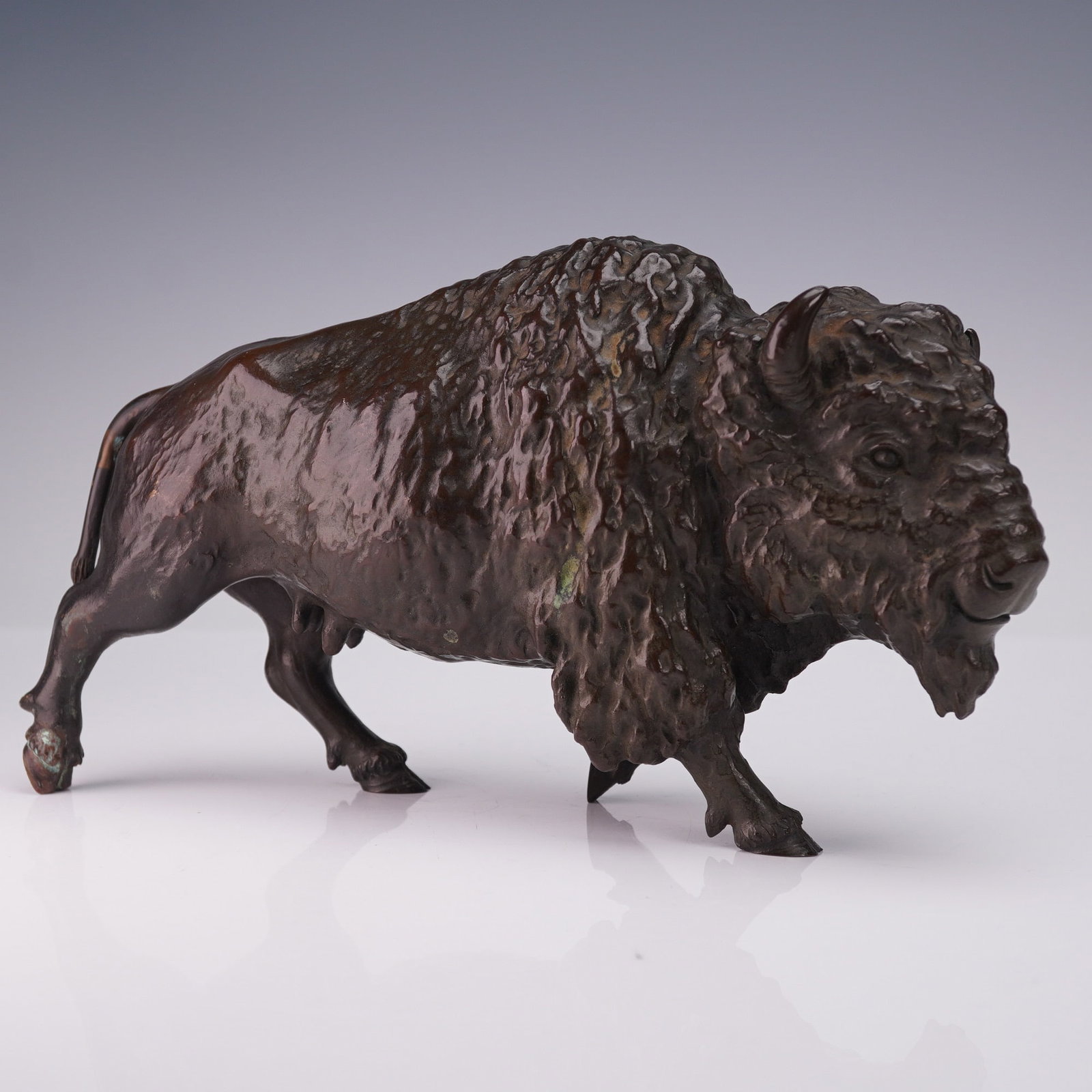 Maruki Co. Japanese Bronze Buffalo Figurine: Japanese bronze buffalo figurine by Maruki Co. The figure is cast in bronze with a dark brown patina and depicts a standing buffalo with detailed facial features, horns, and textured fur across the he