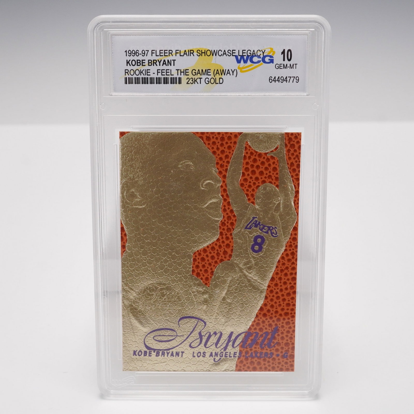 1996-97 Flair Showcase Legacy Kobe Bryant Rookie 23Kt Gold Card WCG Gem: This 1996-97 Flair Showcase Legacy Feel The Game (Away) Kobe Bryant rookie card is finished in 23 karat gold and graded Gem Mint 10 by WCG (World Class Grading). It showcases Kobe in an early-career a