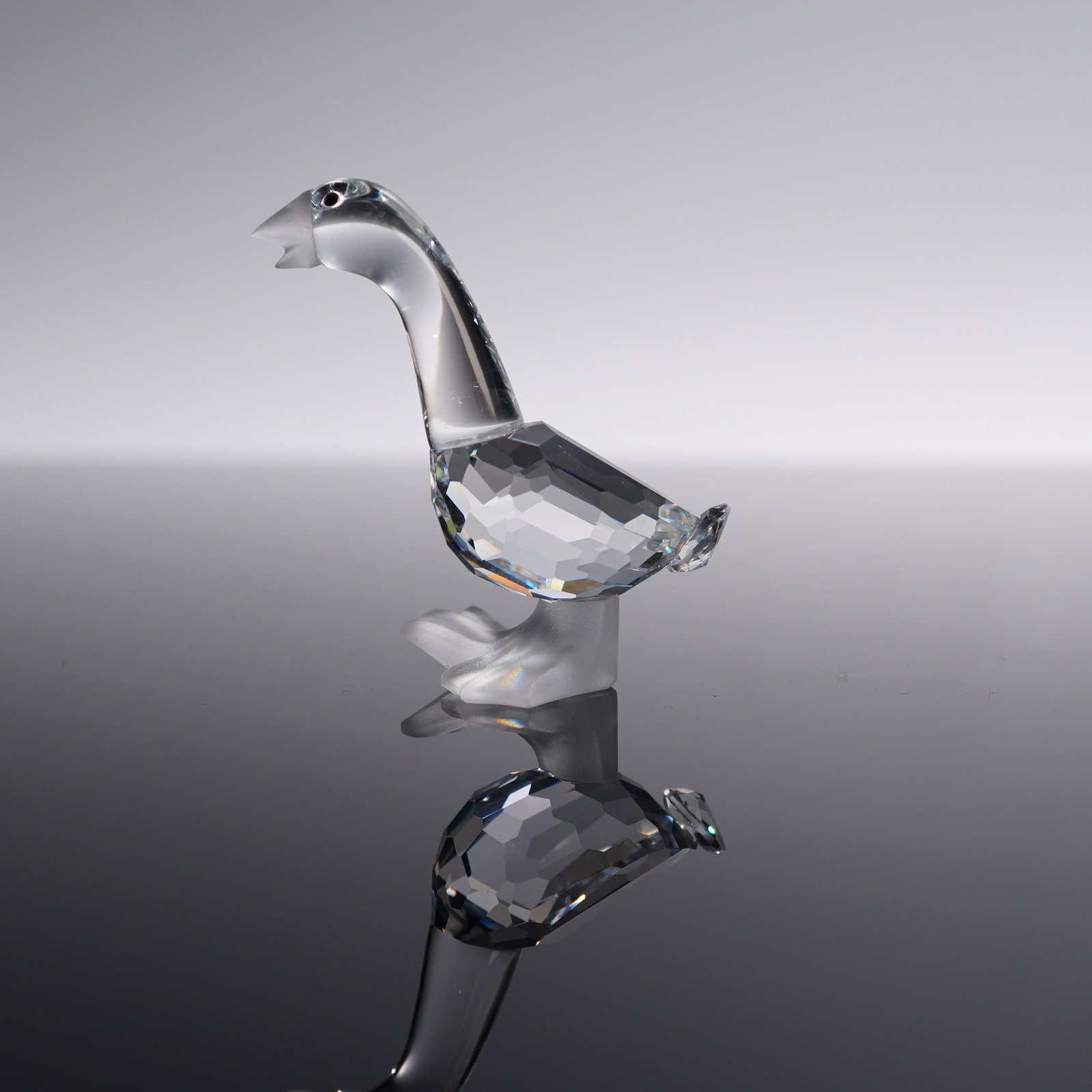 Swarovski Crystal Figurine, Tom Goose: Swarovski Crystal figurine depicting Tom Goose from the Silver Crystal Collection. Crafted in clear faceted crystal with frosted beak and feet, featuring black crystal eyes. Complete with original box