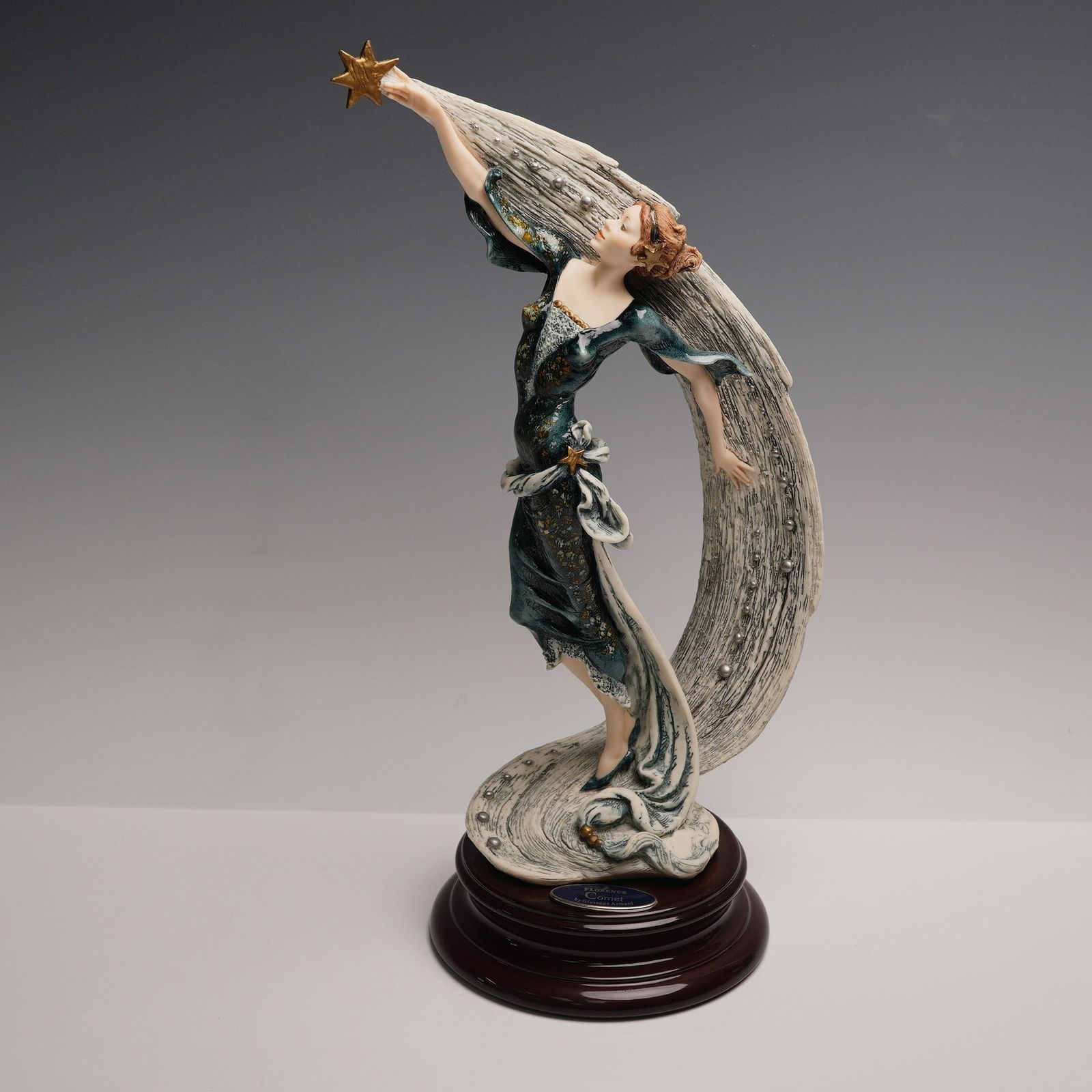 Florence by Giuseppe Armani Figurine, Comet: Limited edition Giuseppe Armani figurine titled Comet, produced for the Florence Sculture d'Arte collection. This exquisitely detailed porcelain sculpture depicts a woman in a flowing midnight blue go