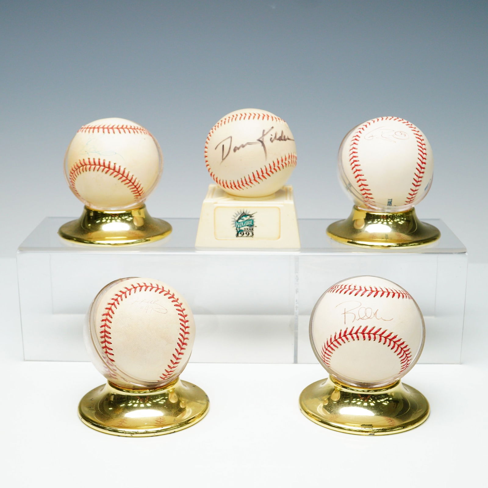 5pc Signed Major League Baseballs Lot w Displays: Lot of five signed baseballs displayed on gold-tone stands. Four are Official Major League Baseballs by Rawlings printed with the signature of Commissioner Allan H. Selig, dating them to the 1998-2014