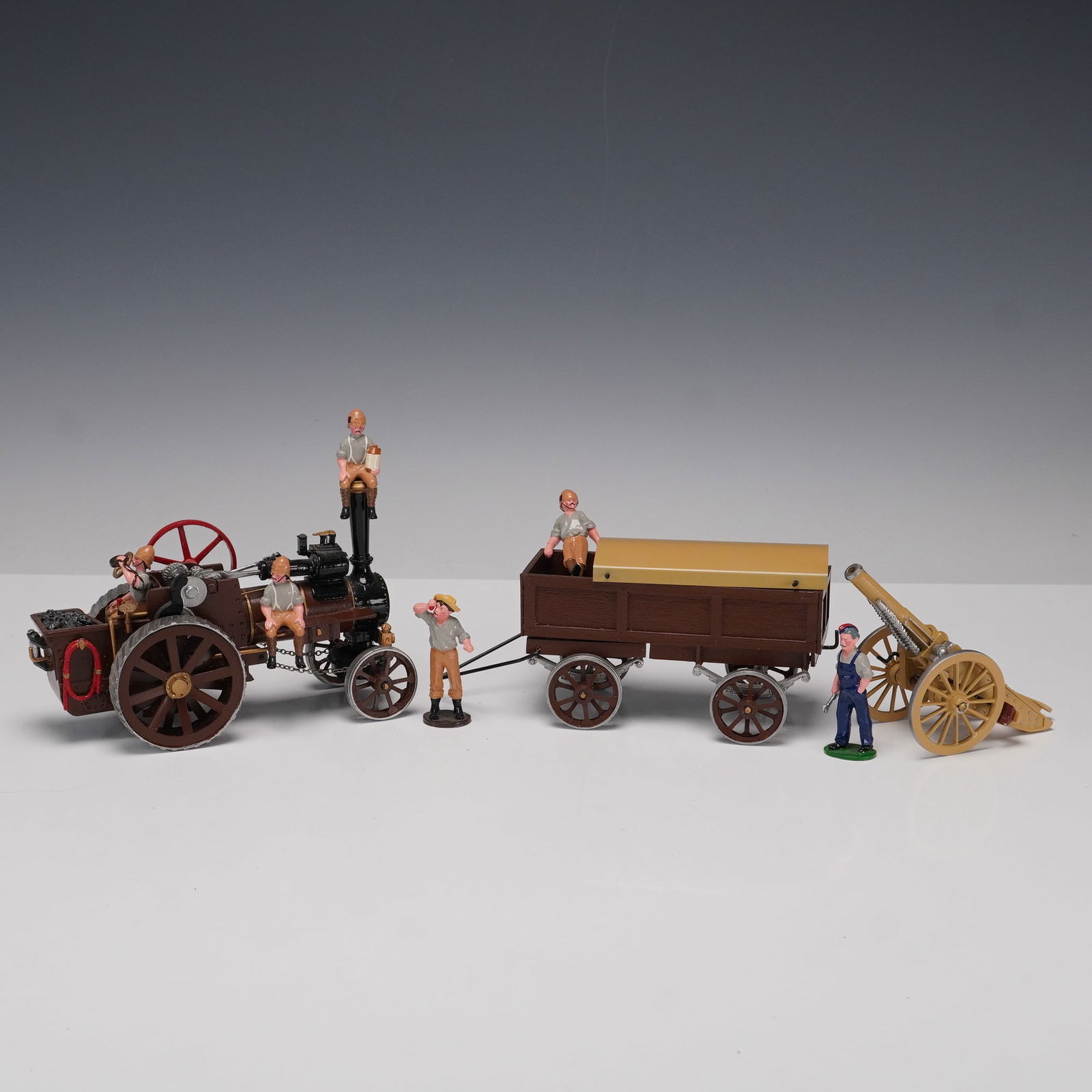 10pc Victorian Field Artillery Toy Convoy with Soldiers, Steam Tractor, Wag: A ten piece military themed vintage style toy set featuring a Victorian era field artillery convoy. The ensemble includes a detailed steam traction engine with moving wheels and red flywheel, a detach