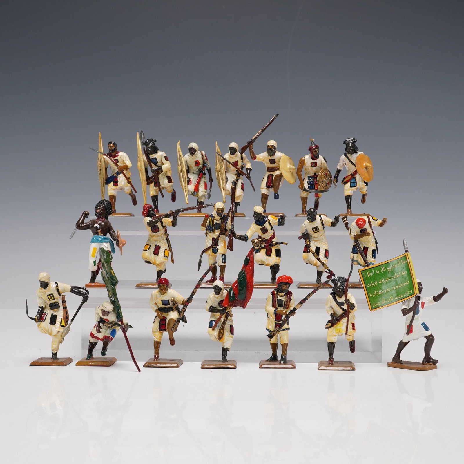 20pc Painted Military Figures: A group of 20 hand-painted military figures in varied dynamic poses, including riflemen, spearmen, and standard bearers with brightly colored flags and shields. Each figure is detailed with distinctiv